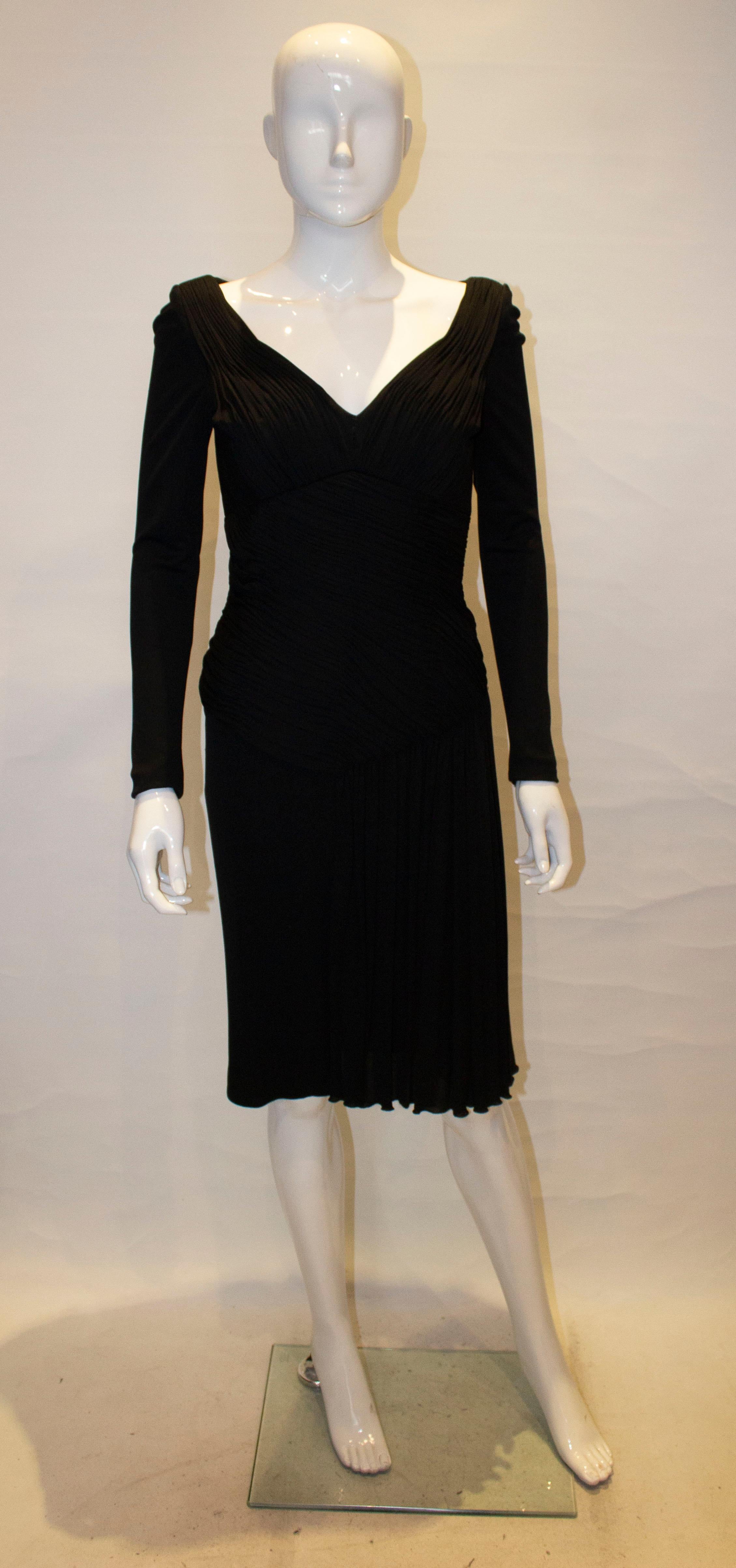 A stunning black vintage cocktail  dress by Vicky Tiel Couture. The dress has a v neckline with draping and folds over the waist area and one side. It has a central back zip ,  is fully lined and hangs beautifully. Bust 35'', length 40''