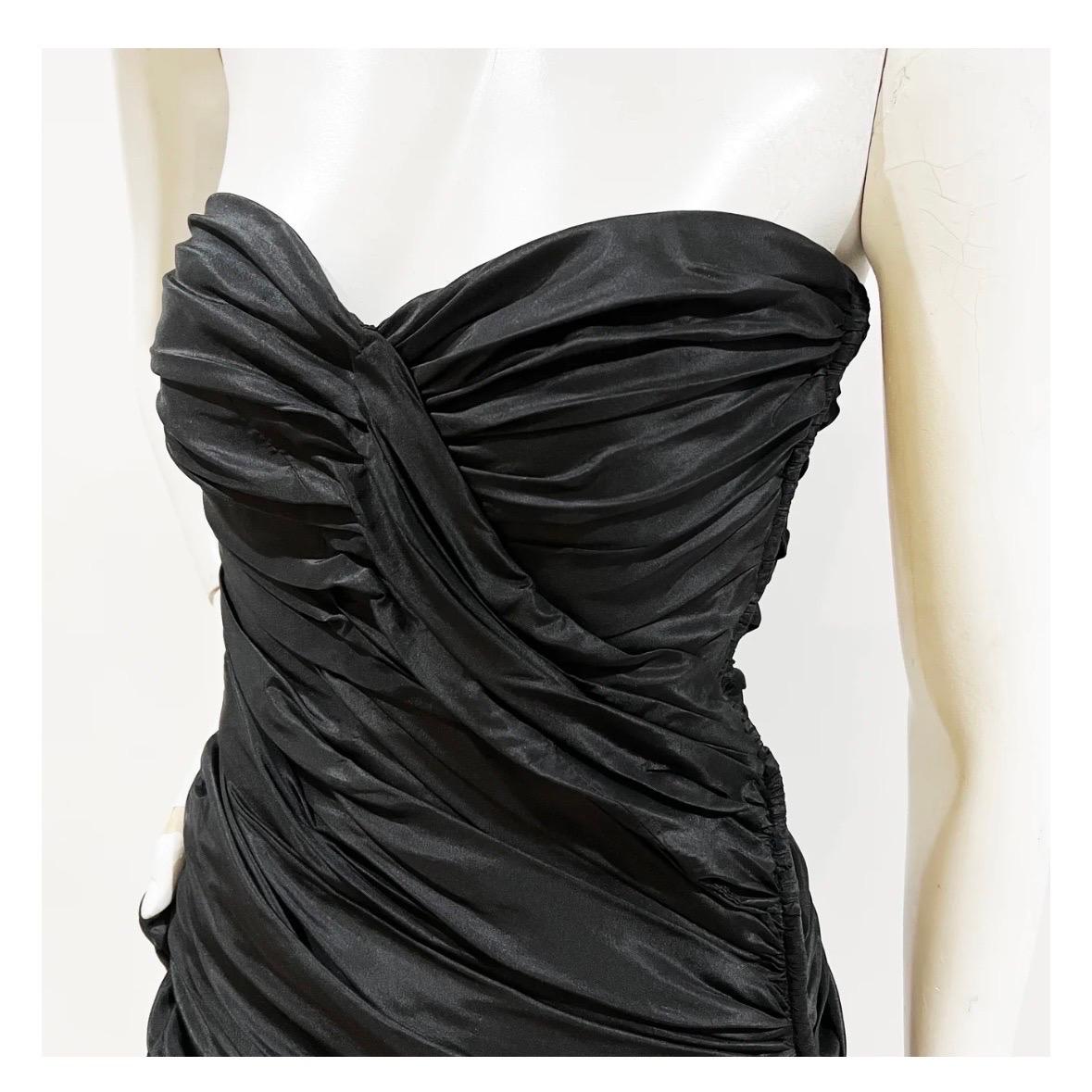 Vintage Strapless Gathered Dress by Vicky Tiel 
Circa 1980's
Made in France
Black 
Sweetheart neckline 
Gathered bodice with asymmetrical wrap effect
Decorative bow on right hip 
Internal waist strap 
Side zipper and hook closure  
Taffeta blend 