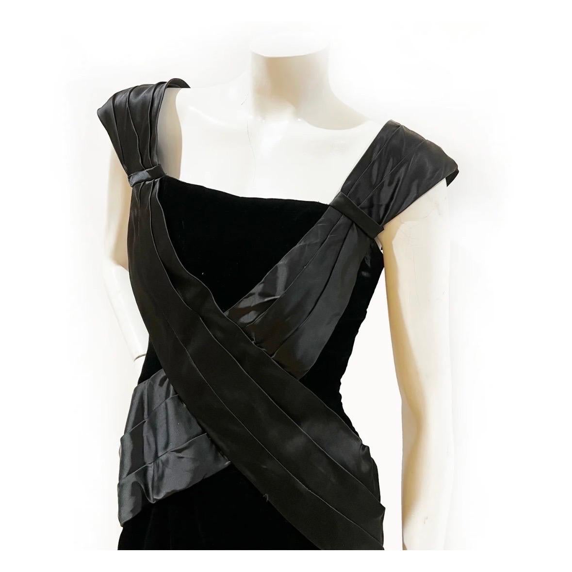 Vintage black velvet dress by Victor Costa for Saks Fifth Avenue 
1980's
Made in USA
Black velvet shell 
Black layered (semi-padded) satin straps that cross through bodice 
Decorative satin continues to back and leads to a decorative, structured