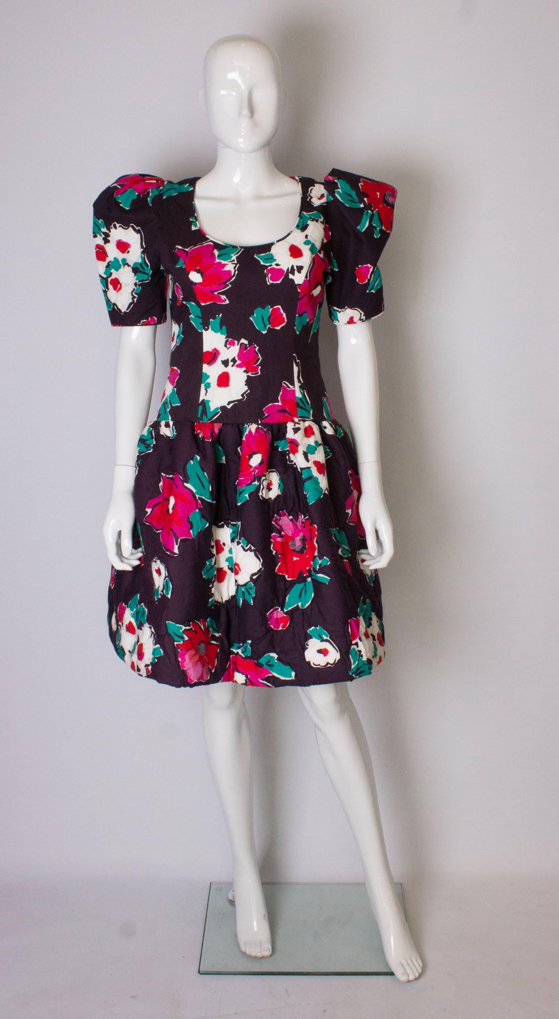 A vintage Victor Costa dress for Bonwit Teller. The dress is cotton in a wonderful floral print. It has a padded skirt with net underskirt and  net in the sleeves with shoulder pads that can be removed.