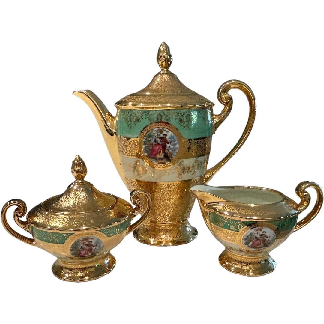 This vintage Victoria Czechoslovakia China tea/coffee set is a beautiful addition to any collection.  The set features delicate hand painted 24k gold decorations and intricate bohemian design, perfect for those who appreciate decorative pieces. 