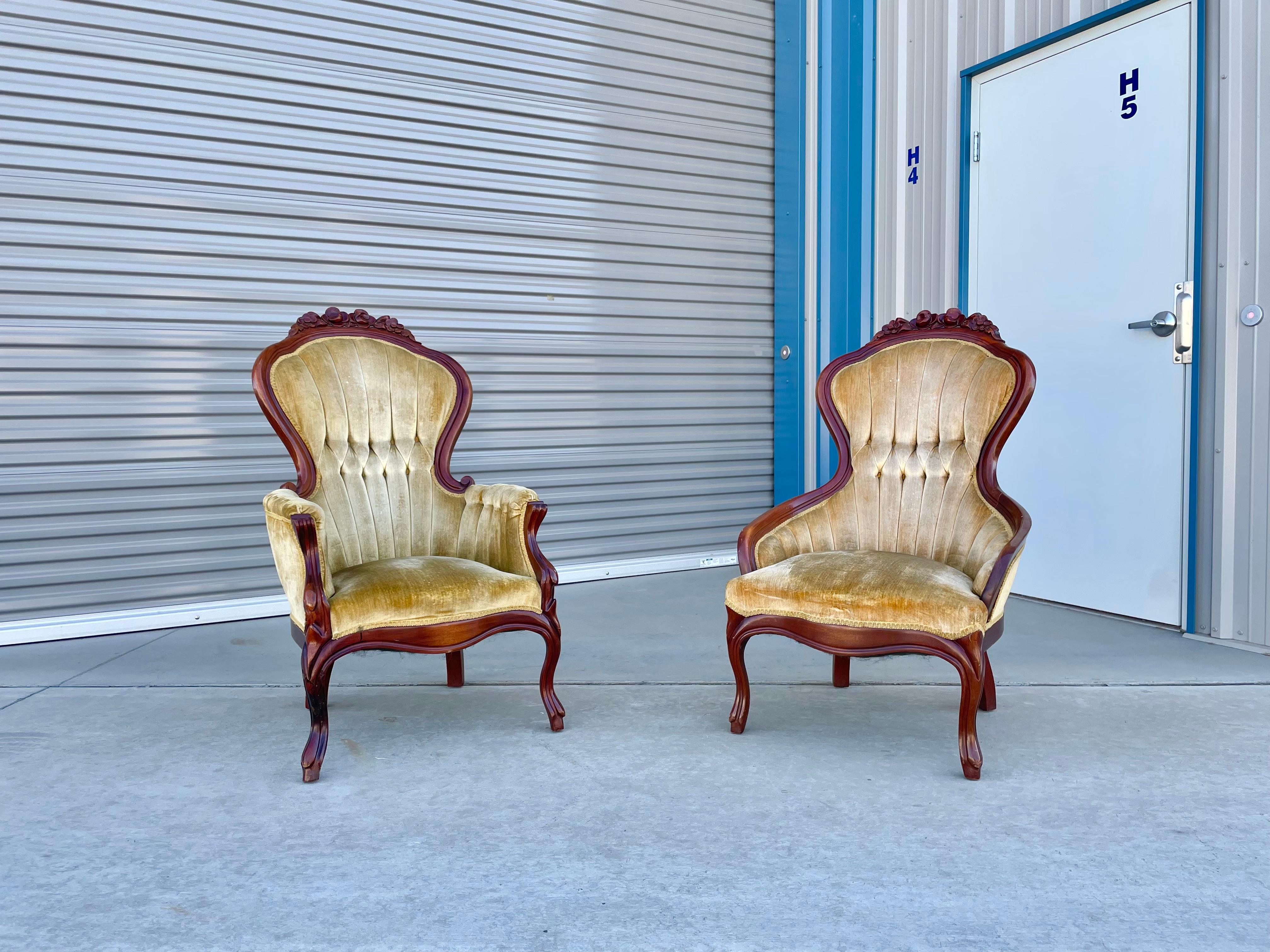 Vintage pair of Victorian-style chairs designed and manufactured by Kimball circa 1930s. The chair features a beautiful, unique sculpture design on the mahogany frame. The chairs also feature their original fabric, the perfect addition to your home.