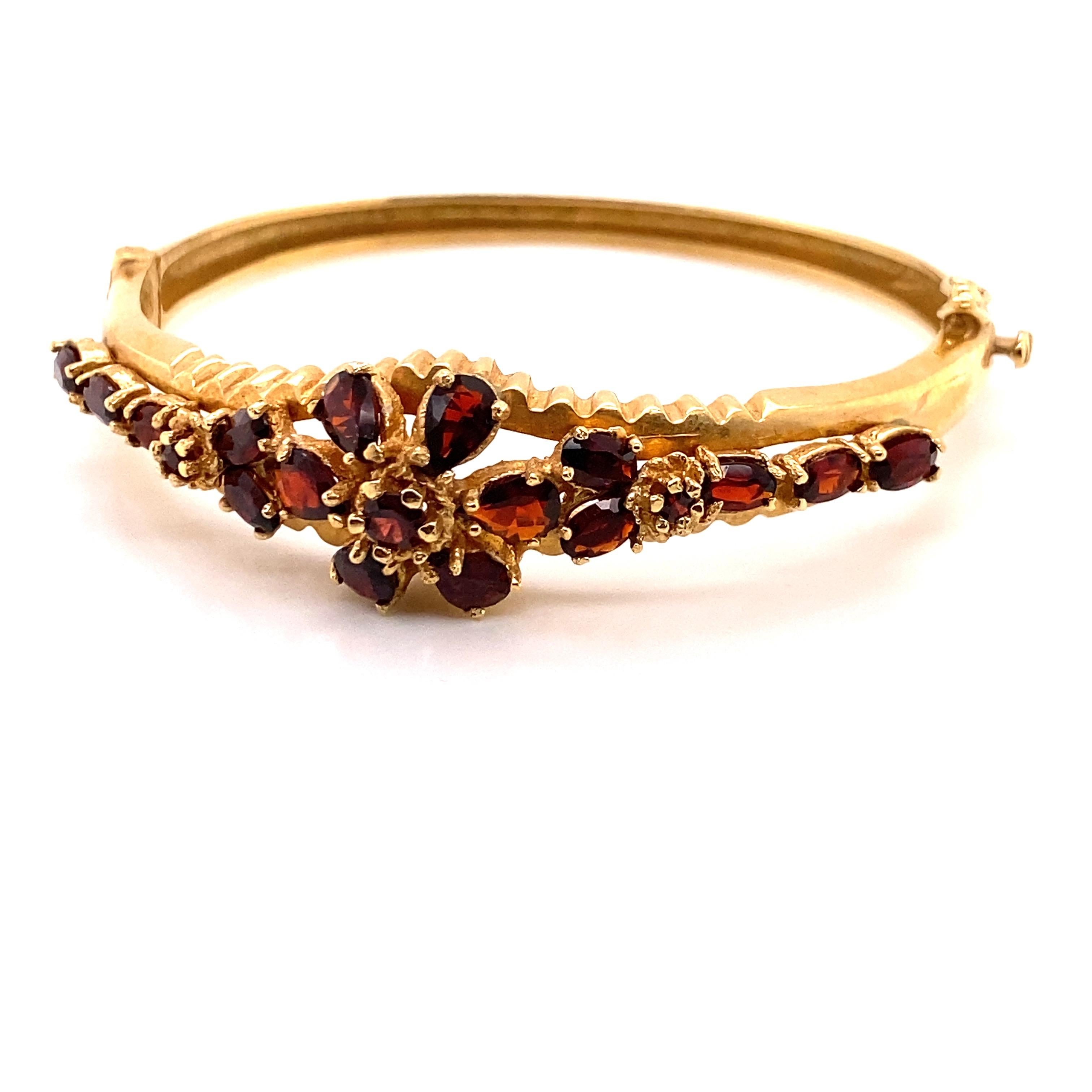 Vintage Victorian Reproduction Garnet Bangle Bracelet - The bracelet contains 19 pear shape, oval and round garnets. The width on top is 15mm and tapers down to 4mm on the bottom. The inside diameter is 2 inches high and 2.25 inches wide. The