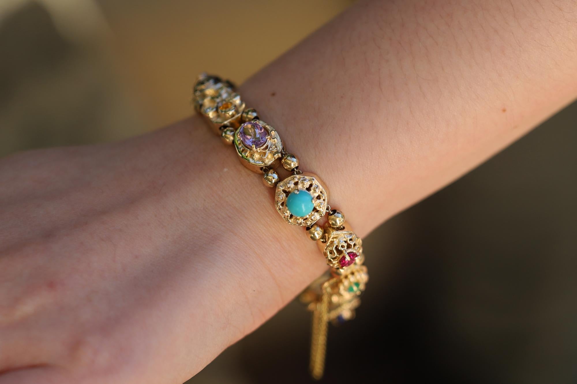 OTHER SLIDE BRACELET DESCRIPTION

Vintage and lively with charm, this Victorian inspired slide bracelet displays a multitude of natural, multi color gemstones. From pearls to diamonds, to vibrant green peridot, citrine, turquoise, amethyst, sapphire
