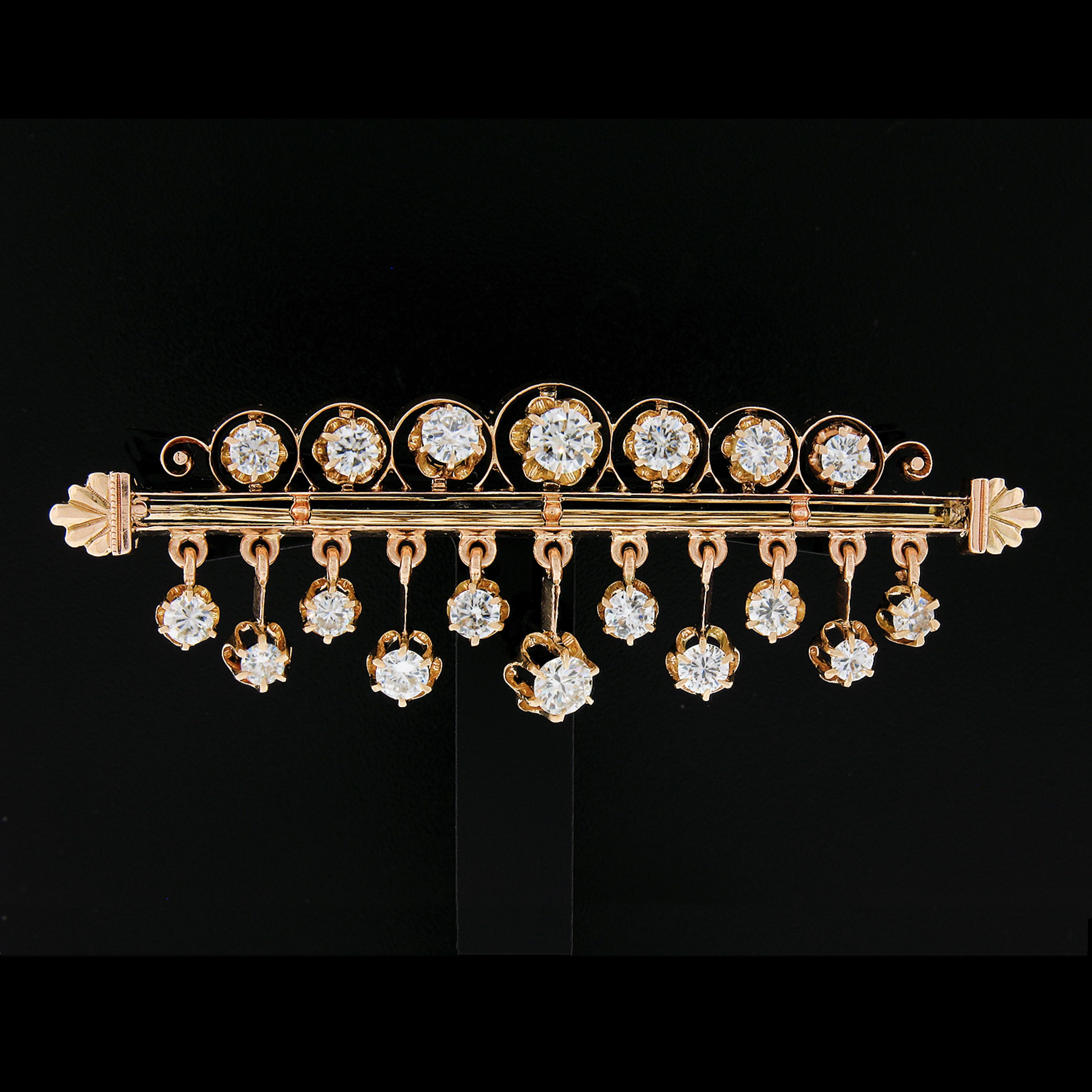 Here we have an absolutely magnificent Victorian revival diamond dangle bar pin crafted in solid 18k rosy yellow gold. The pin features two straight bars that carry 18 round brilliants and old transitional cut diamonds, all prong set in beautiful