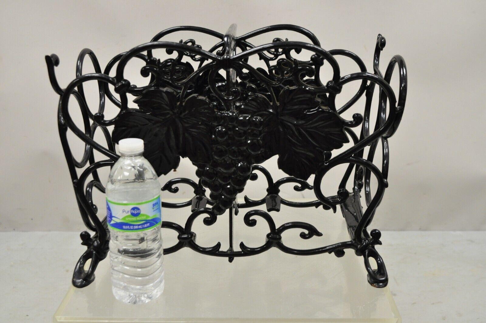 Vintage Victorian Style Black Cast iron 6 wine bottle rack holder with grapes. Item features a black finish, maple leaf and grape cluster vine design, heavy construction, divider to middle, great style and form, 6 slots for wine bottles. Circa Mid