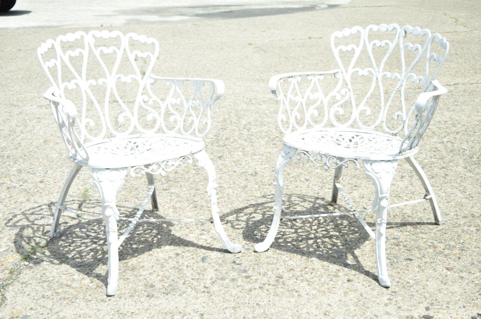 Vintage Victorian Style Cast aluminum heart back outdoor garden chair - a Pair. Item features a shapely heart backs, lattice seats, cast aluminum construction, very nice set, great style and form. Circa Mid to Late 20th Century. Measurements: 30