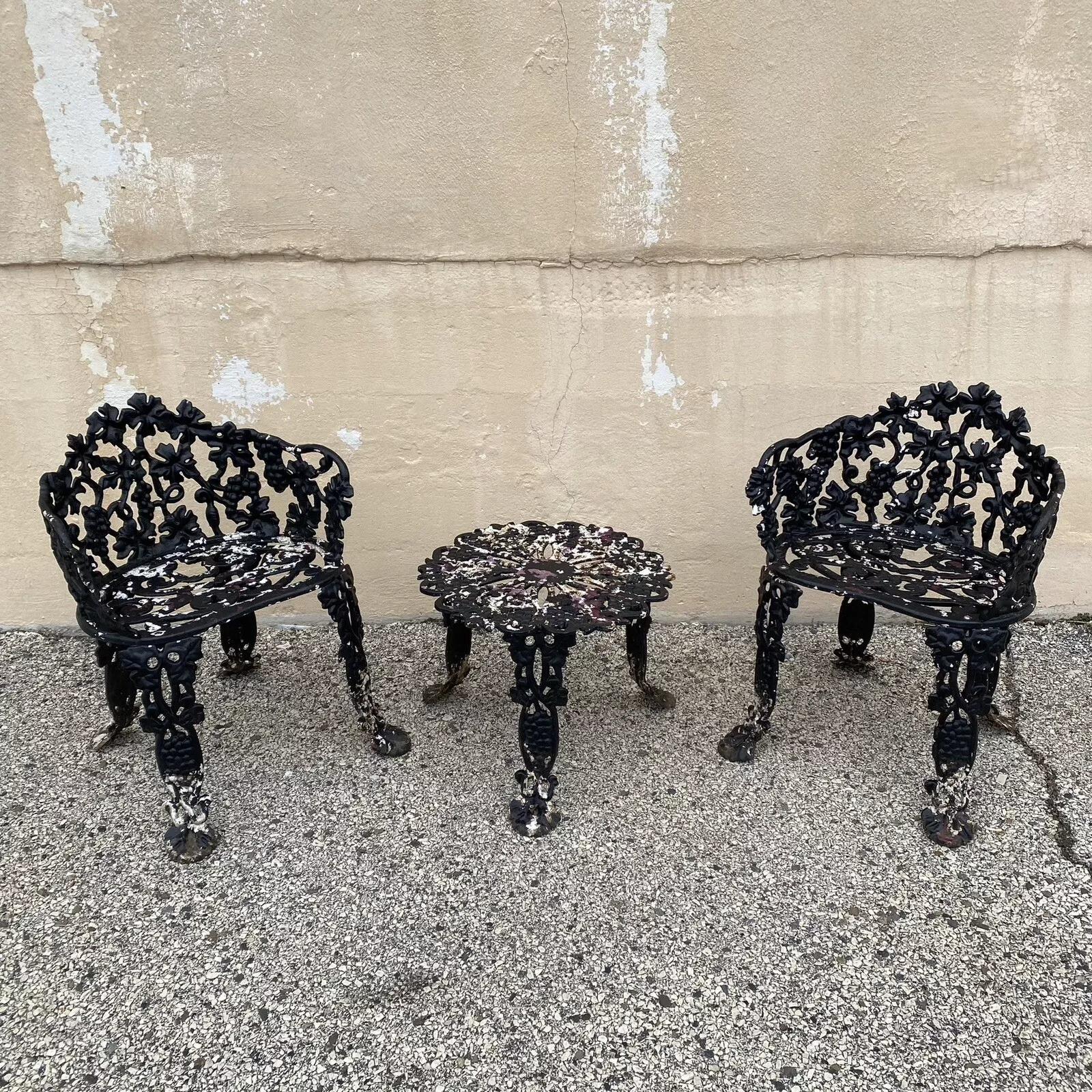 Vintage Victorian Style Cast Iron Grapevine Grape Leaf Garden Patio Set - 3 Pcs. Set includes two armchairs and one small side table all in heavy cast iron. Circa Mid 20th Century. Measurements: Chairs: 28
