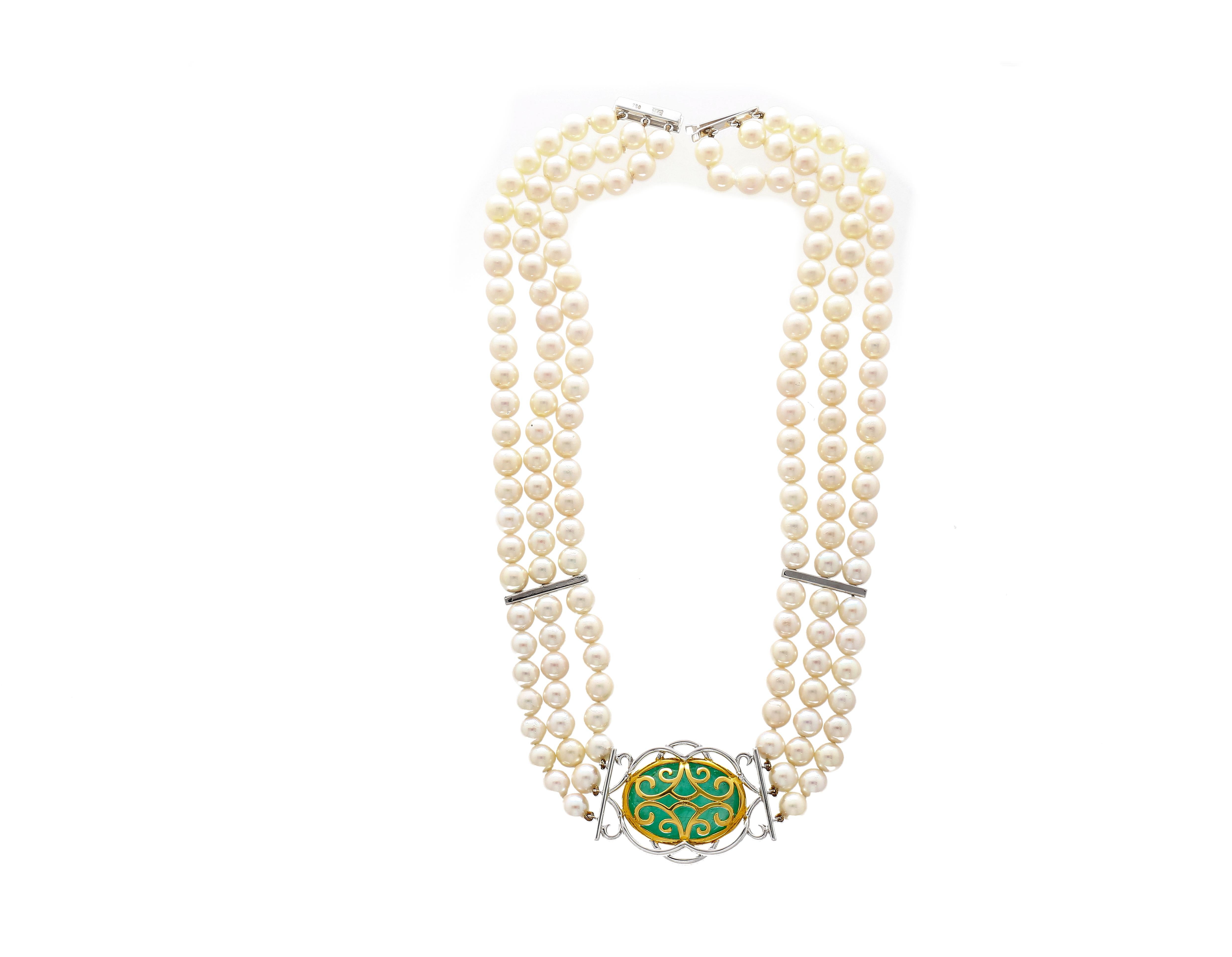 This necklace features a cabochon cut green emerald bezel set pendant. Paired with 150 round cut diamond side stones, this beautiful necklace is strung together with 3 strands of pearls. This vintage choker necklace sits beautifully on the neck as a