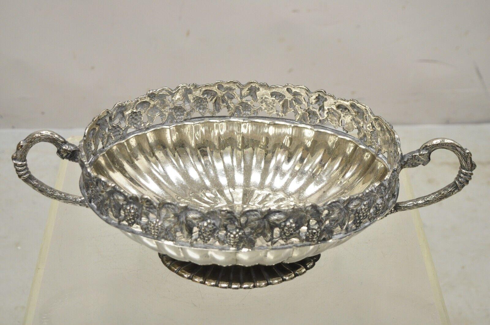 Vintage Victorian Style Grapevine silver plated oval twin handle fruit bowl. Item features a pierced grapevine gallery, ornate branch and vine twin handles, raised on base, nice oval form, very nice antique item. Circa Mid 20th Century.