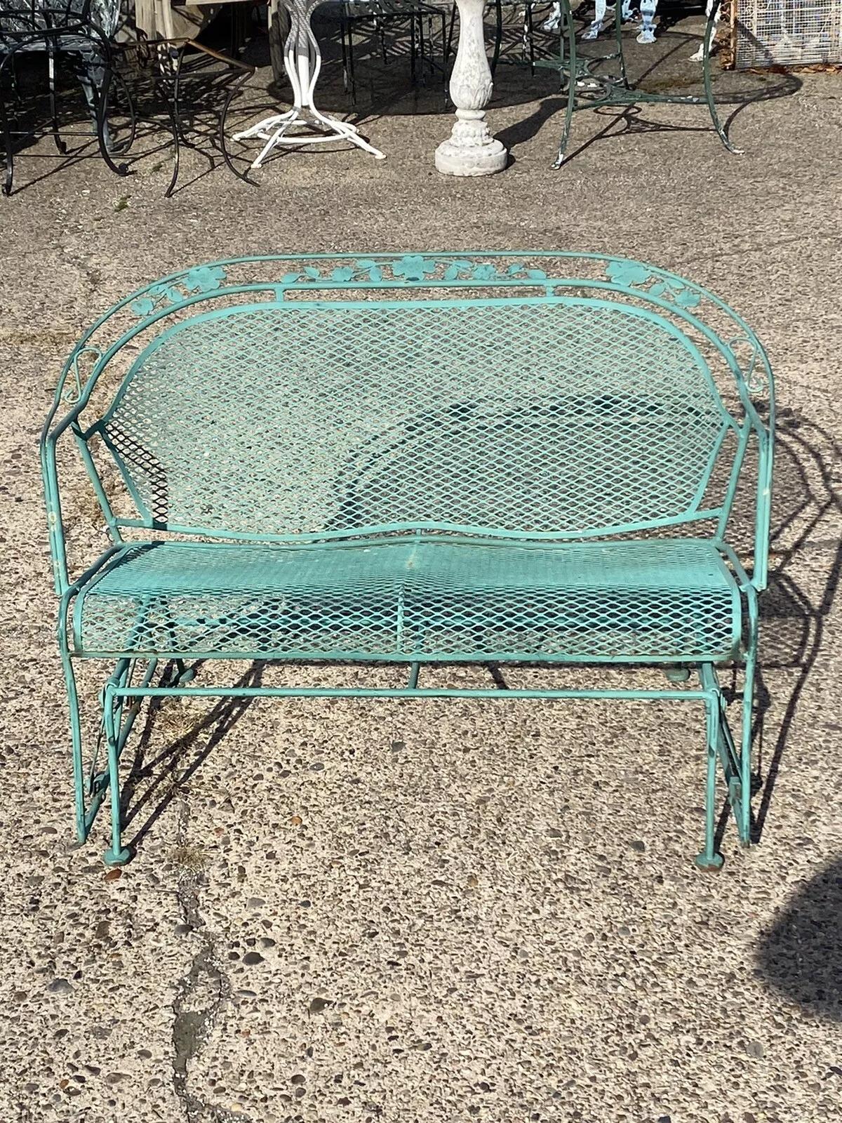 Vintage Victorian Style Green Wrought Iron Outdoor Garden Leaf Glider Loveseat Bench. Circa Late 20th Century. Measurements: 31