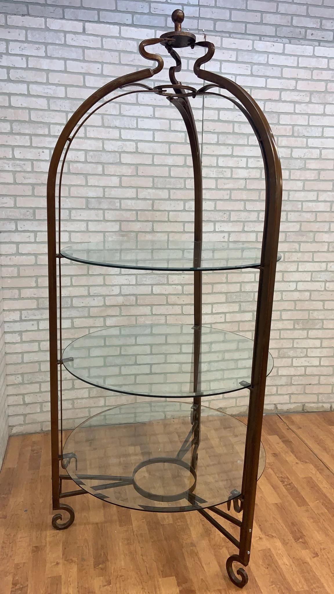 Vintage Victorian Style Iron and Beveled Circular Glass Shelve Boutique/Closet Display Stand

This vintage Victorian style display stand is a striking and ornate piece of furniture. This display stand features a tall, wrought-iron frame that is