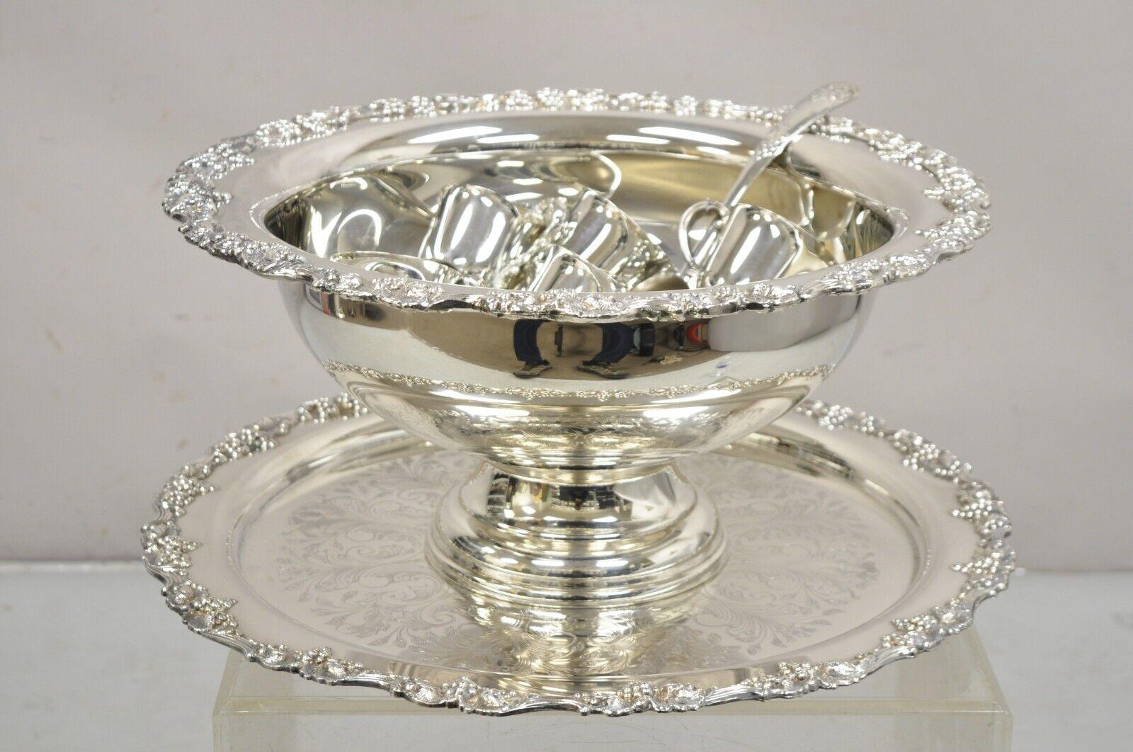 Vintage Victorian Style Silver Plated Punch Bowl Tray Set with 12 Cups - 15 pcs. Item features a grapevine pattern, 12 cups, round ornate tray/platter, large pedestal punch bowl, 1 ladle spoon, very nice vintage set. Circa Late 20th