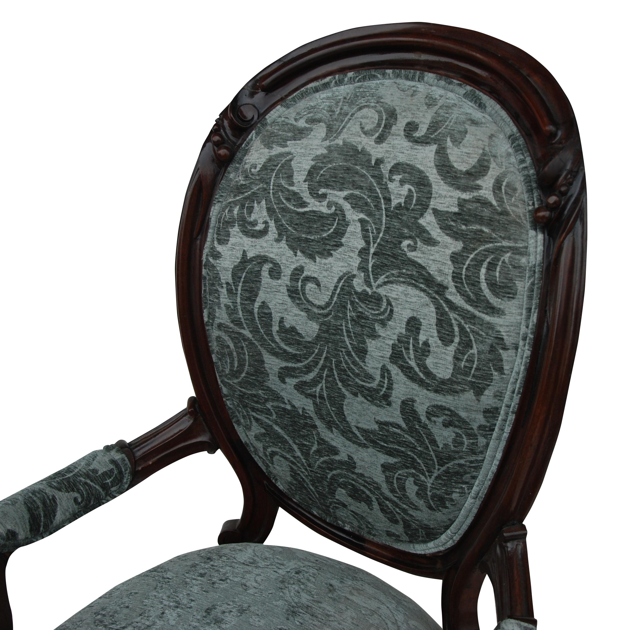 Vintage Victorian style spoon back lounge chair

Charming, decorative chair with a padded arched spoon back over upholstered seat in a flocked damask upholstery. Ebonized frames. Carved arms and claw front feet with sabre back legs.
 