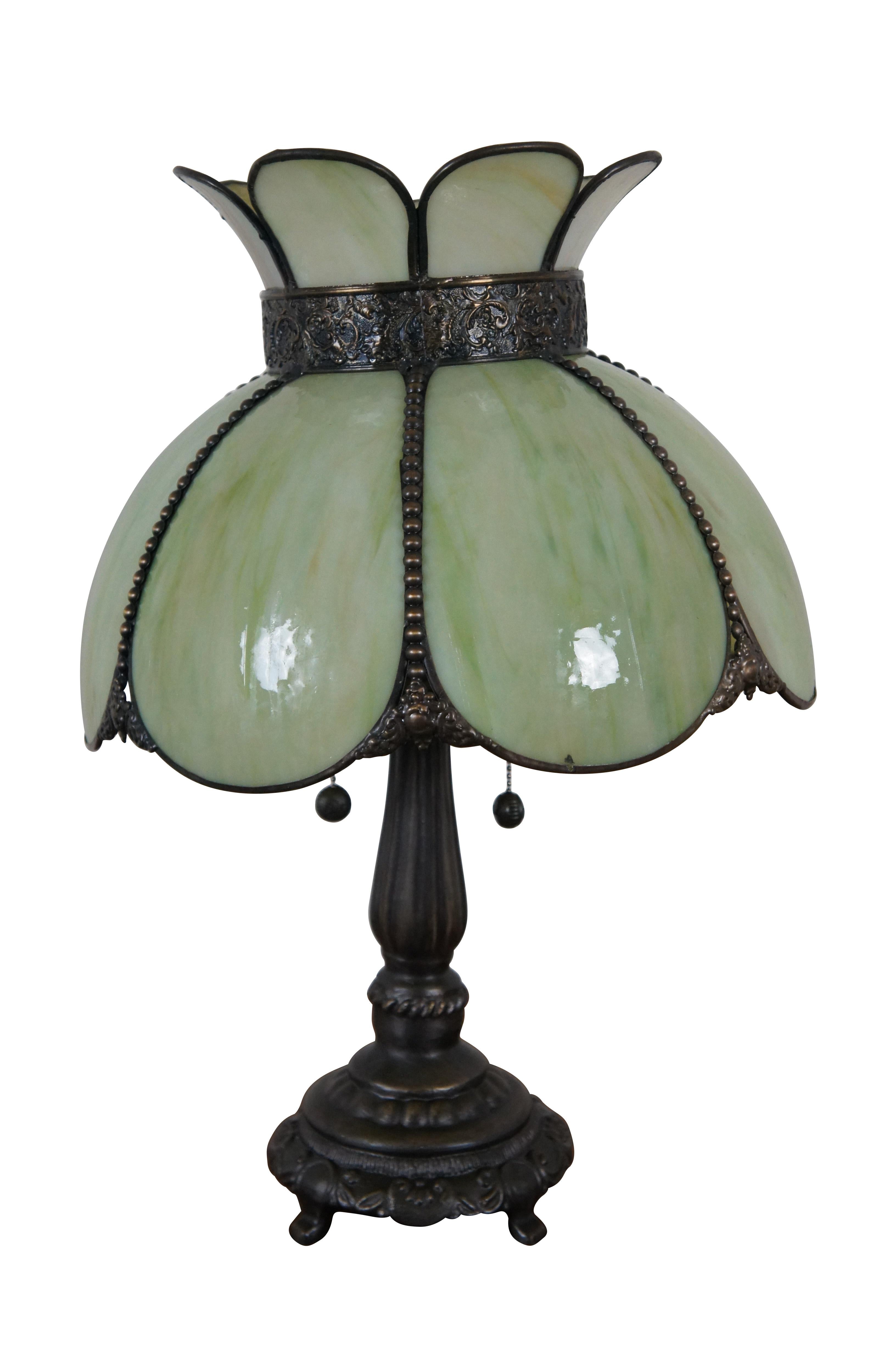 Vintage Victorian / Art Nouveau / Tiffany style two light parlor table lamp featuring green slag glass crown or tulip shaped shade supported by tapered column with footed base.

Dimensions:
15” x 21.5” (Diameter x Height)