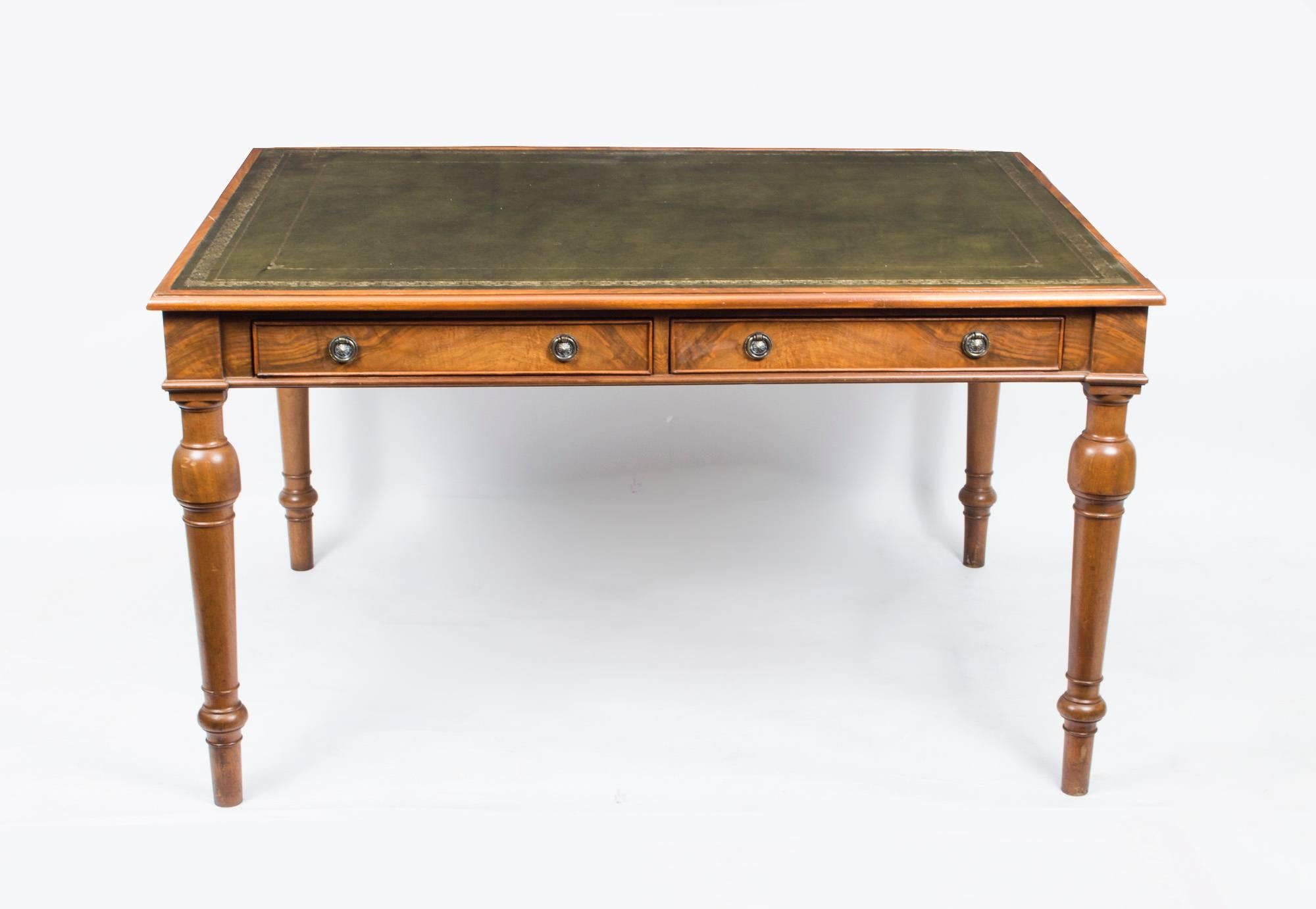 This is a lovely vintage English writing table, circa 1930 in date.

This desk has been crafted from beautiful burr walnut and features two spacious drawers and a gold-tooled faded green leather writing surface.

It is finished all round so it
