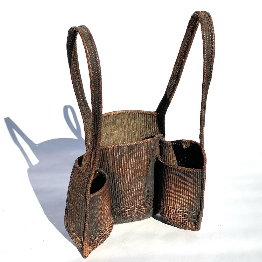Vintage Vietnamese Front Pack Basket. Cleverly woven with three open compartments and two shoulder straps with a variation of weave patterns and well finished trim. To be worn on the front and excellent for gathering leaves and berries. Woven of