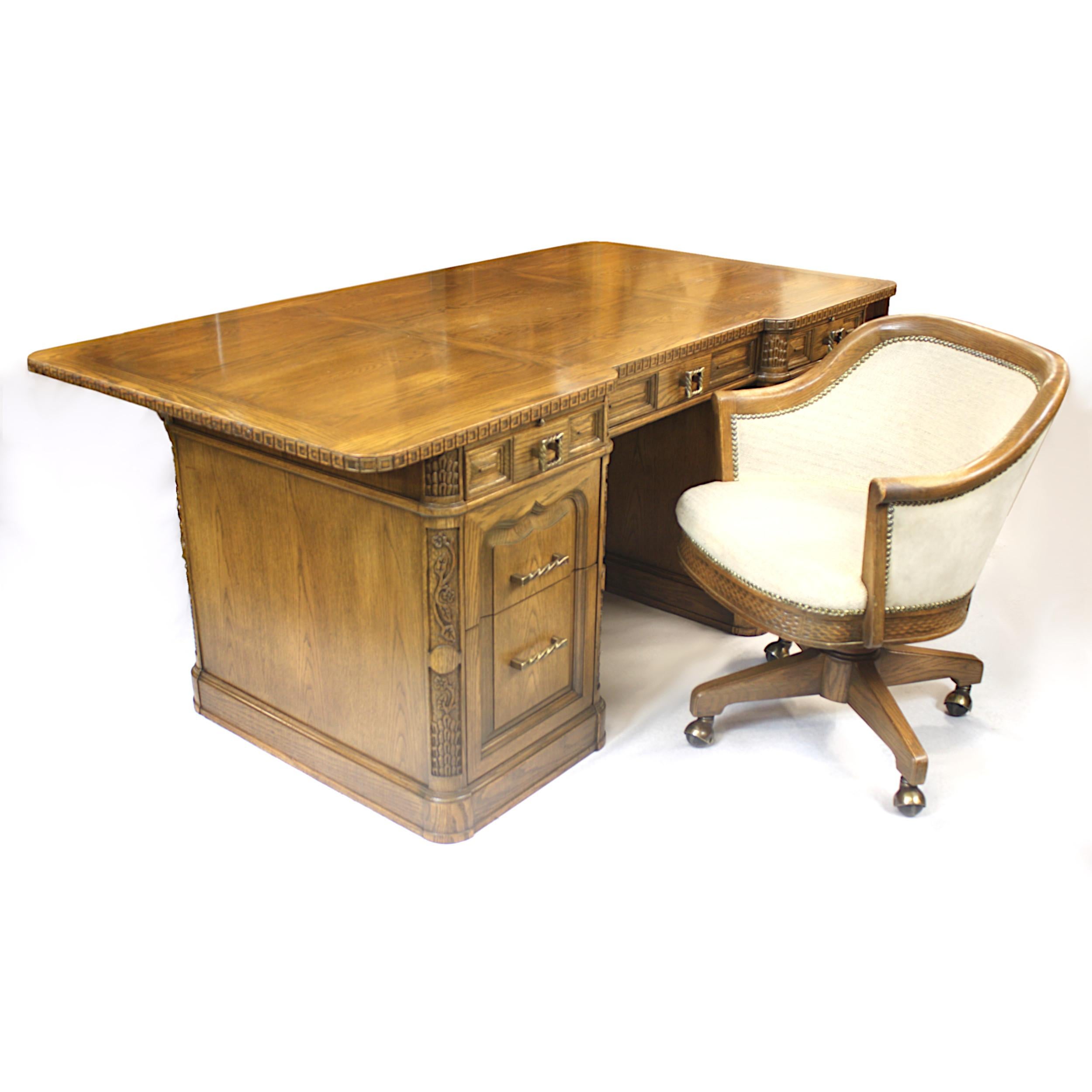 Excellent vintage executive desk and chair in the Classic Viking Oak style by the Romweber Furniture Co. of Batesville, IN. This grandiose desk features wonderful relief carved details, solid oak construction, and solid brass hardware. This is a