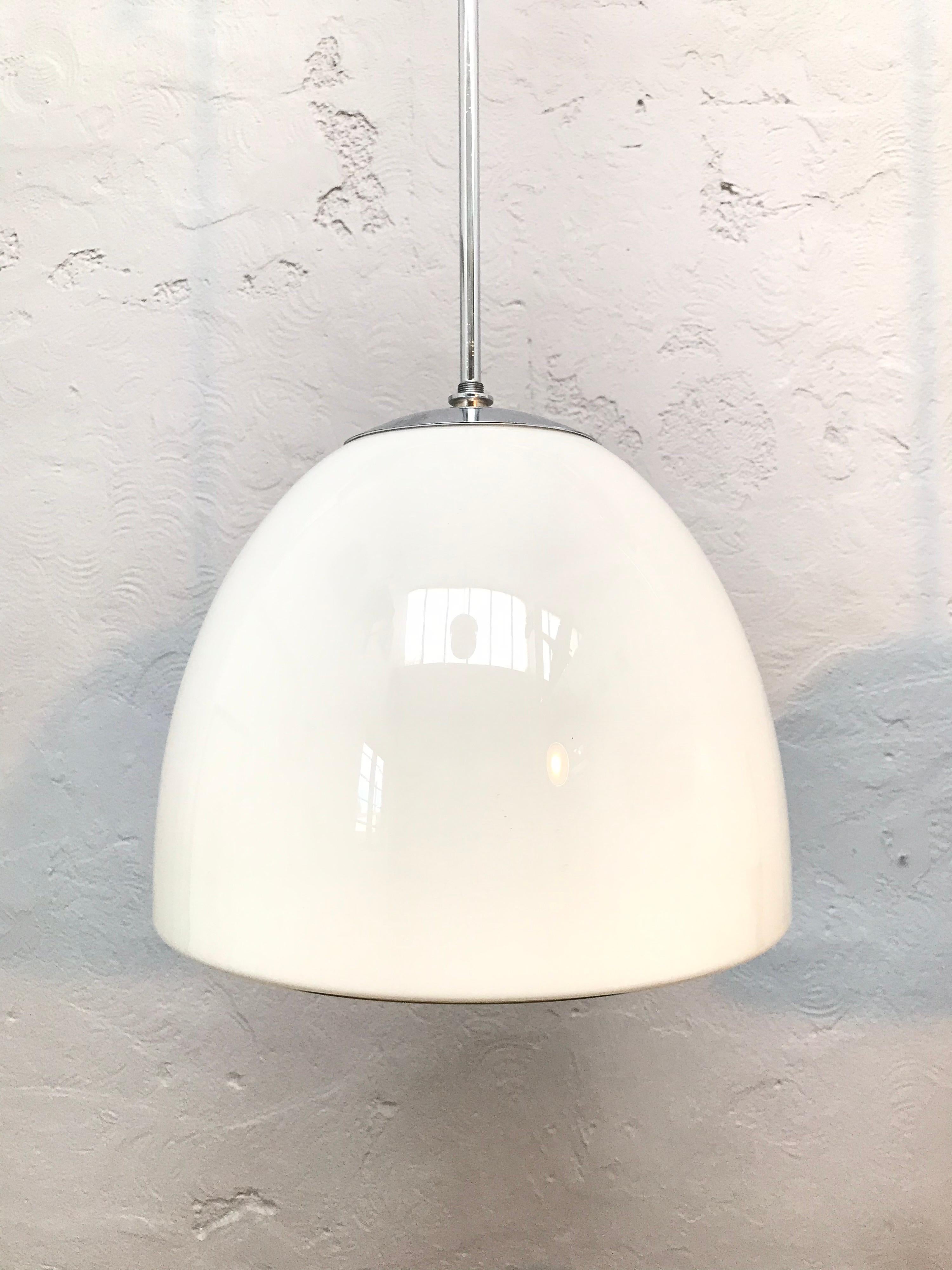 Vintage Danish Vilhelm Lauritzen for Louis Poulsen opaline glass bell shaped pendant chandeliers.
In original condition with new wiring and grounded.
Hanging on a 60cm long nickel-plated copper pipe that can be shortened and rethreaded if so