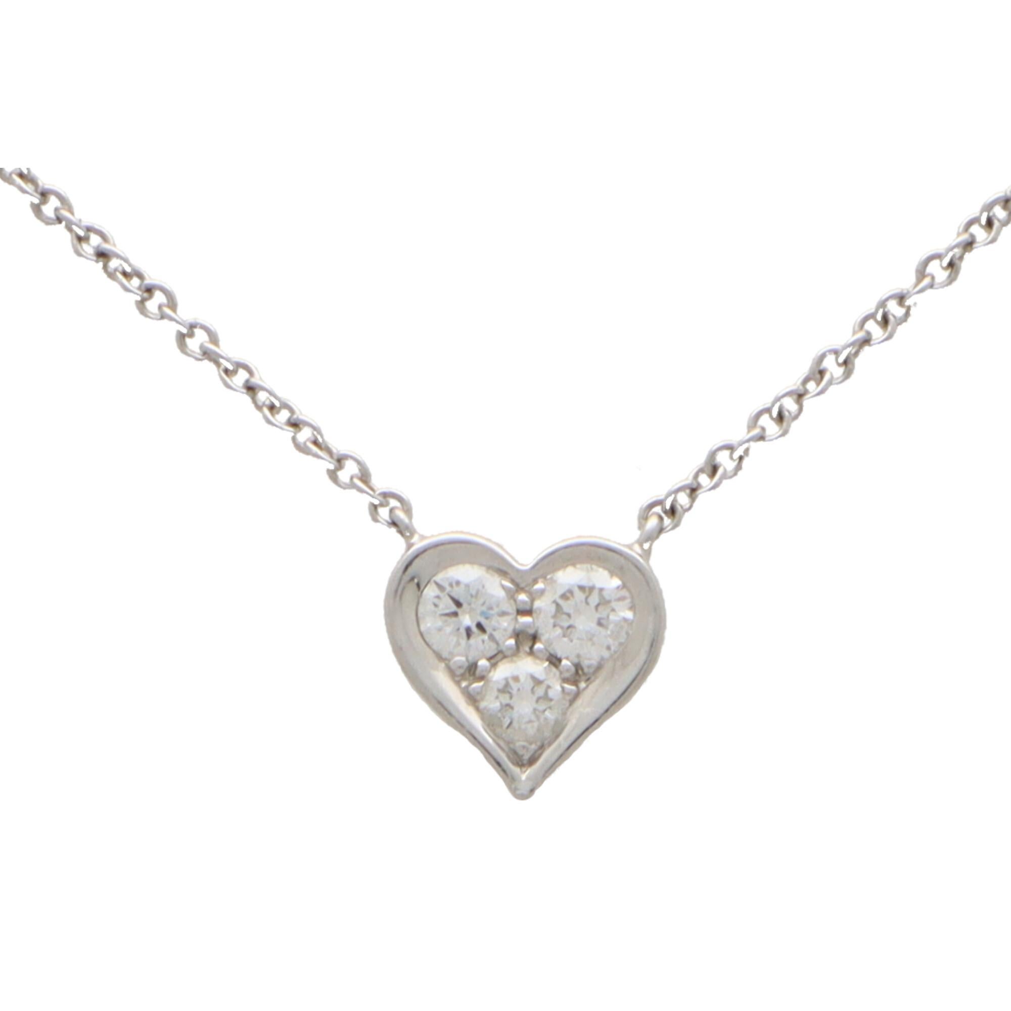  A beautiful signed Tiffany & Co. diamond heart pendant set in platinum.

The pendant is centrally set with three round brilliant cut diamonds within a solid platinum heart setting. The pendant hangs on a 16-inch platinum trace chain.

The added