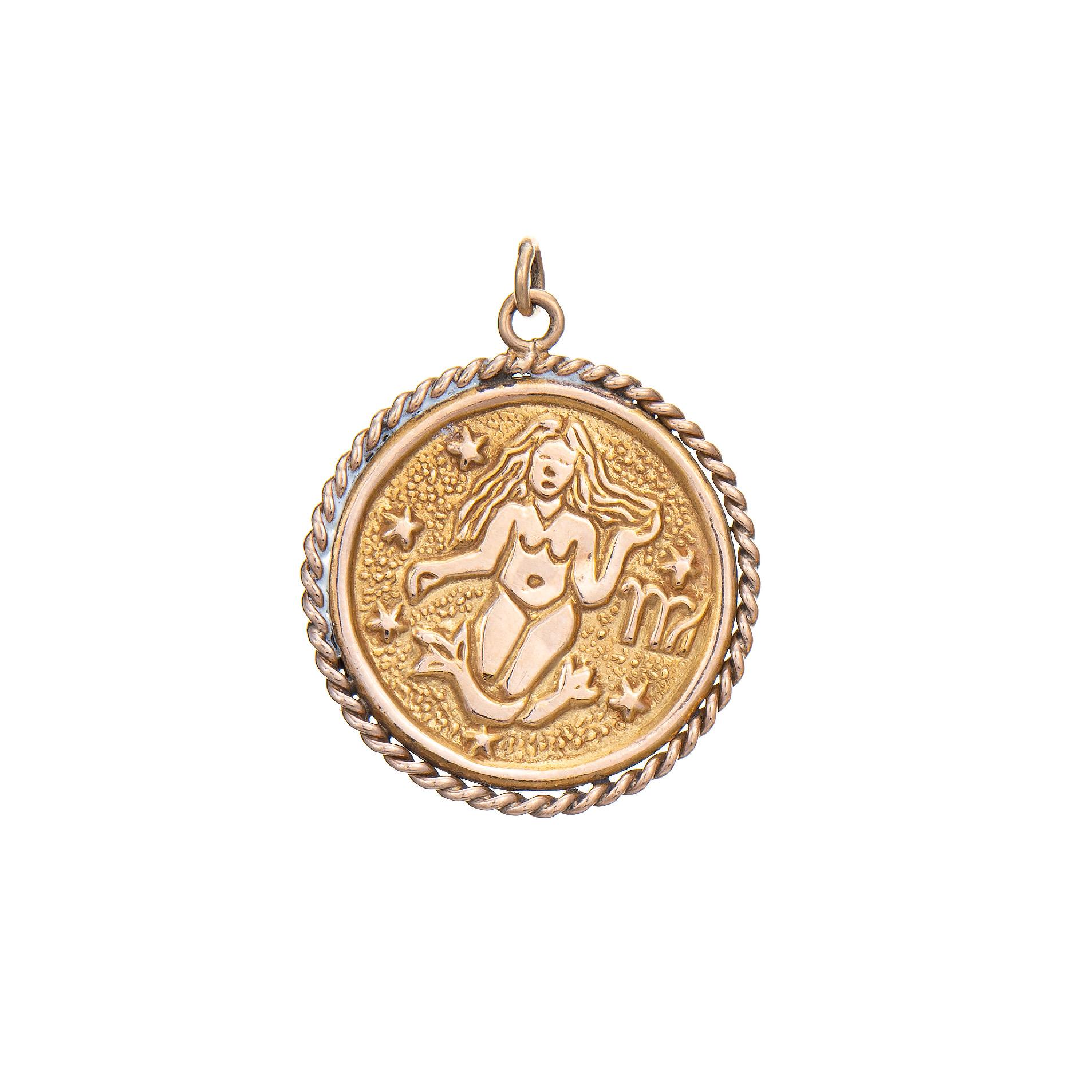 Finely detailed Virgo medallion pendant crafted in 14k yellow gold (circa 1970s).   

The medallion pendant measures 26mm diameter (1.02 inches) and features a double-sided Virgo design. The bale measures 3mm wide and can accommodate a thin to