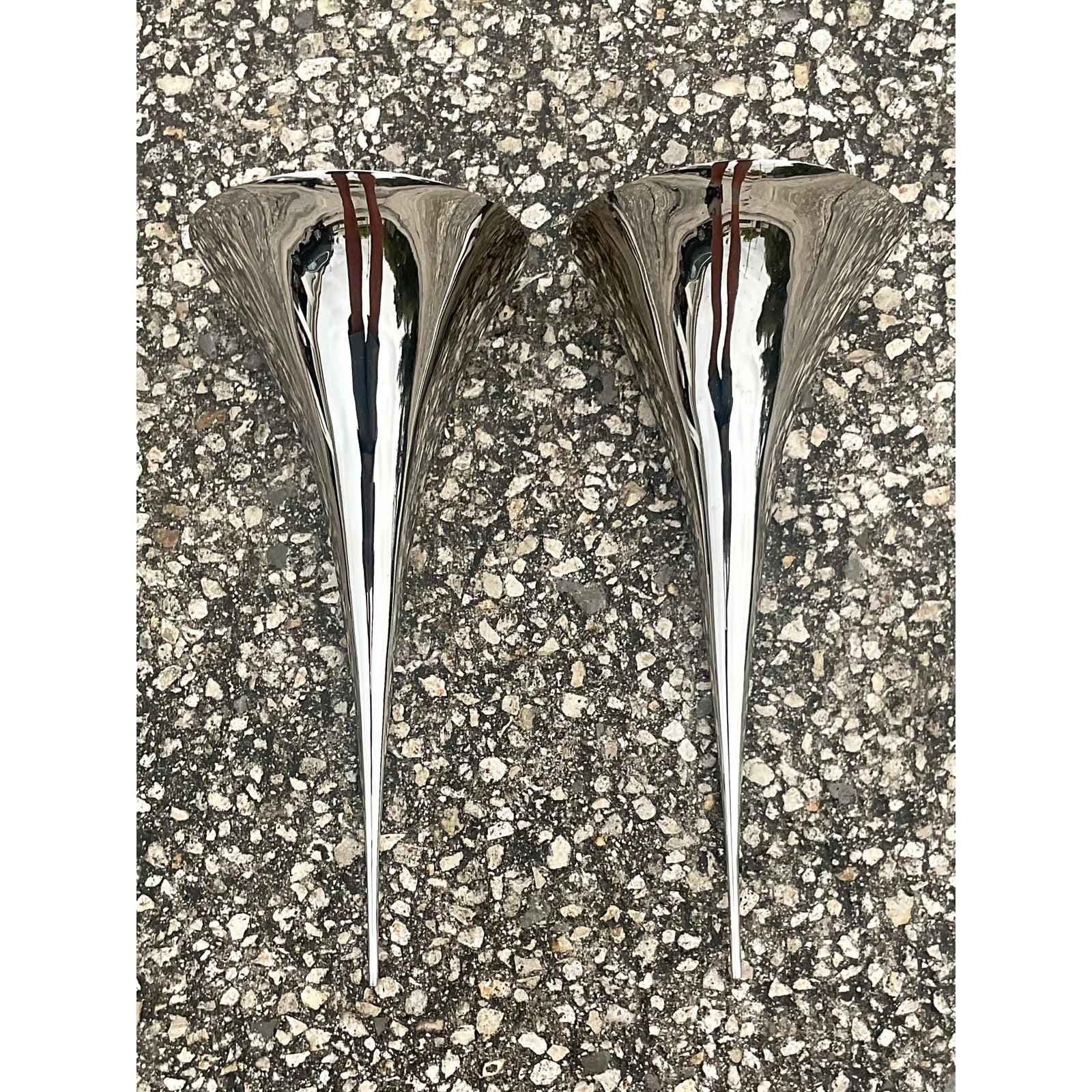 Incredible pair of vintage Visual Comfort wall sconces. Mirror polished stainless steel in a chic organic shape. The coveted Aerin Alina design. Acquired from a Palm Beach estate.