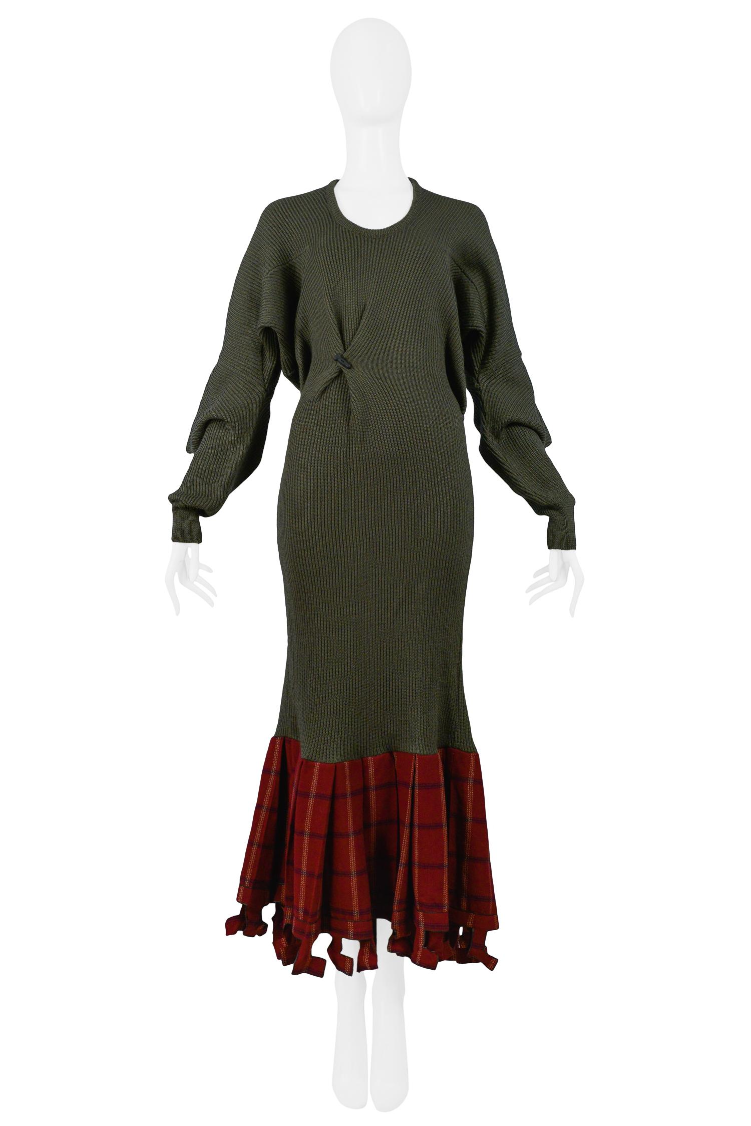 Vintage Westwood McLaren Worlds End olive wool ribbed knit dress featuring a red pleated plaid flounce hem with cut-out detailing, oversized angular elbows, and iconic black penis buttons on the front and back bodice. From the Clint Eastwood AW