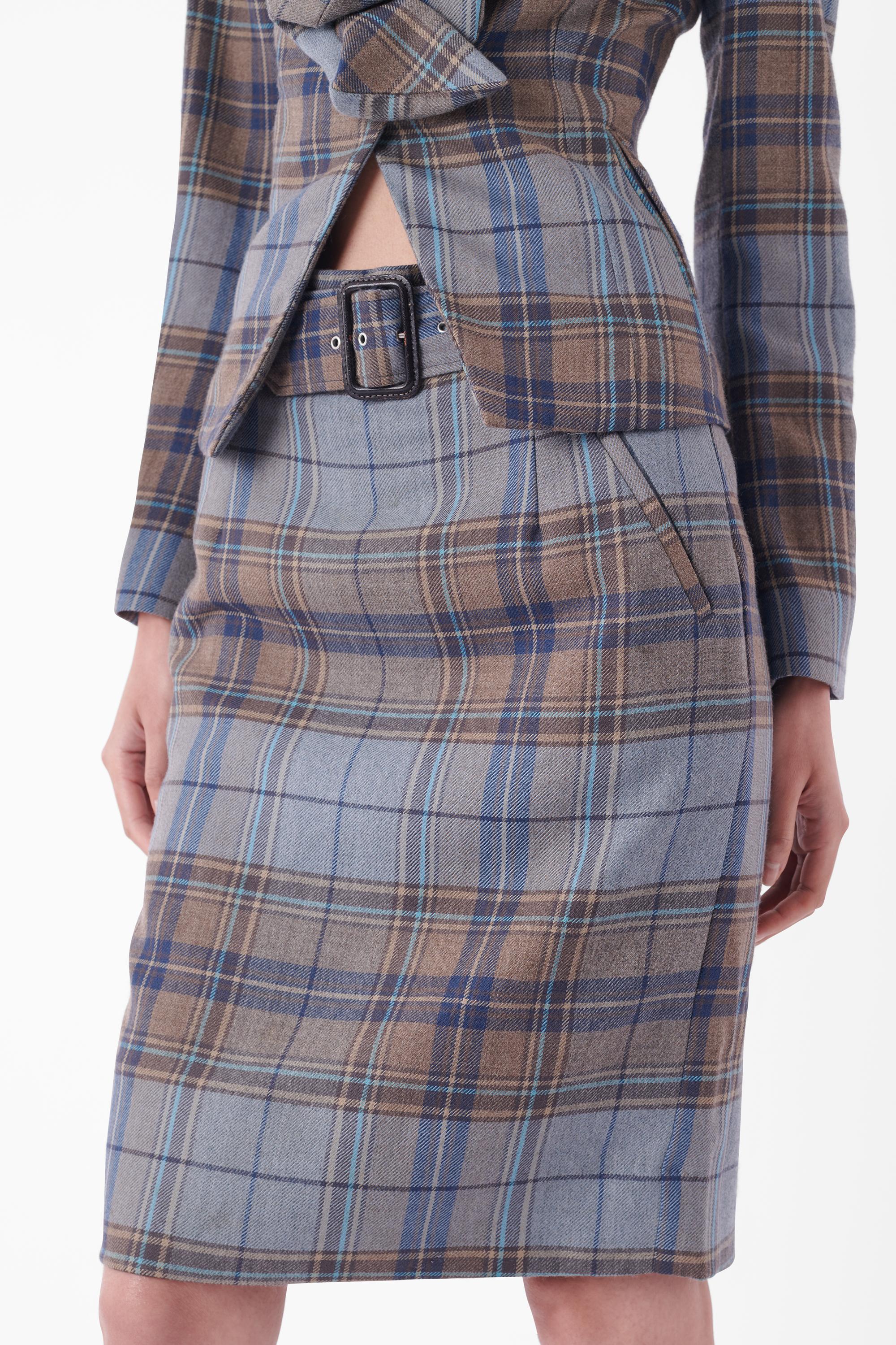 Vivienne Westwood Fall Winter 2012 blue tartan set. Runways look 14 and 16. Jacket features a drunken asymmetric neckline, non-functioning pockets, orb printed button front closure, darted silhouette and red label tag. Skirt features a matching