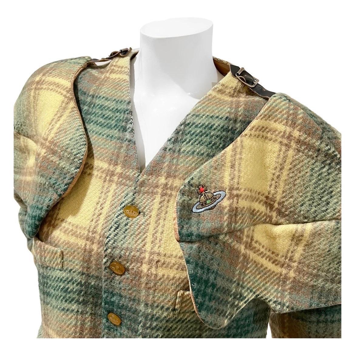 Vintage Plaid Armor Vest by Vivienne Westwood 
Fall / Winter 1988
Made in England
Green/yellow plaid
Vest has detachable and adjustable long sleeves 
Leather adjustable straps with silver-tone buckle detail
Front button closure 
Dual top slit