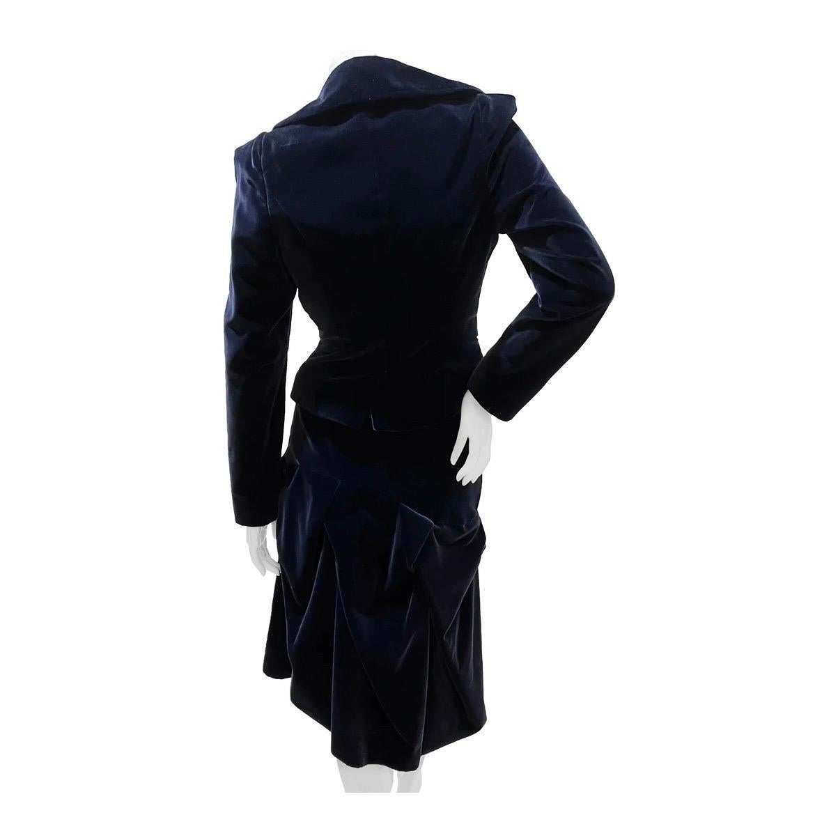 Velvet Bustier & Skirt Suit by Vivienne Westwood Red Label  
Circa late 1990s
Made in Italy
Navy blue velvet
Dual front button and dual snap closure
Dual open side pockets
Bubble style hem
Long sleeve
Skirt has light ruched detail
Asymmetrical skirt