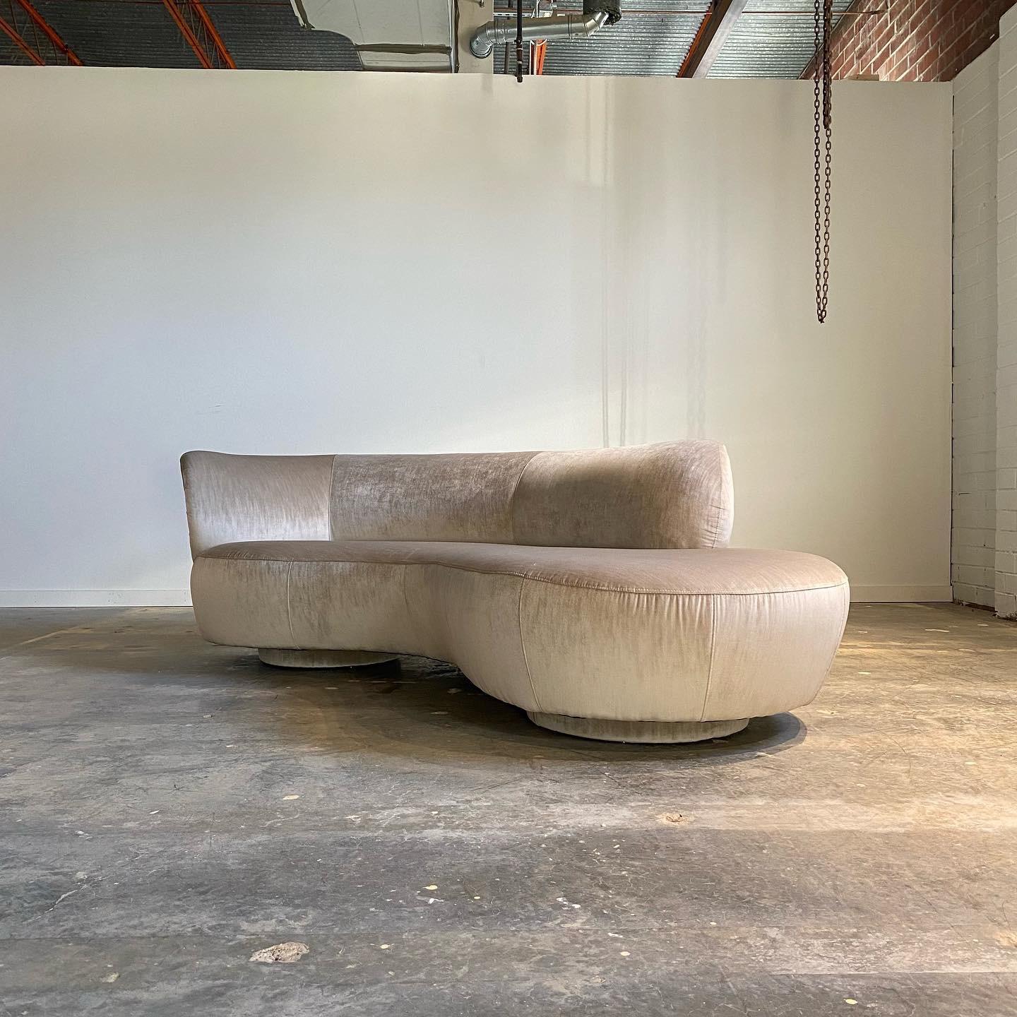With sculptural curves and organic shape this vintage sofa looks great from all sides. Expertly recovered in a champagne velvet and ready to place. A stunning vintage design with an aesthetic sure to last.