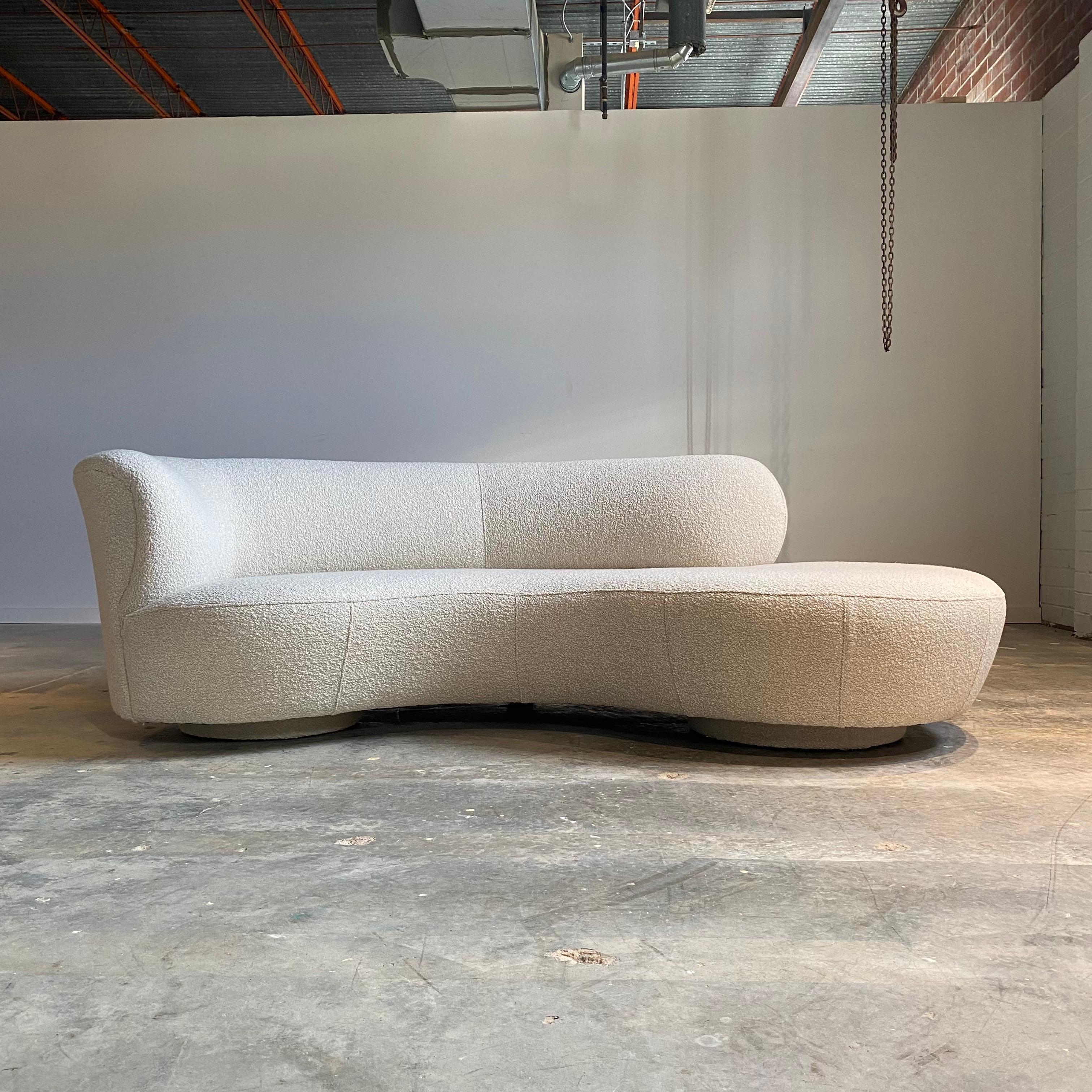 With sculptural curves and organic shape this vintage sofa looks great from all sides. Expertly recovered in an ivory boucle and ready to place. A stunning vintage design with an aesthetic sure to last.