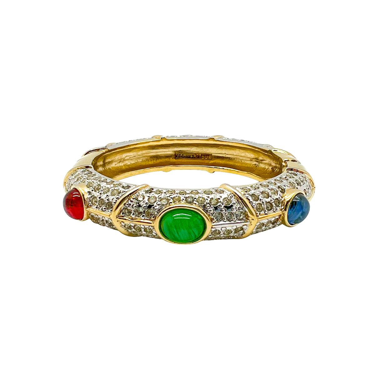 A dreamy Vintage Vogue Bijoux Jewelled Cuff. Emulating a pave set diamond bangle set with emerald, ruby, and sapphire glass cabochon stones this is a seriously glamorous finishing touch.
The Italian jewellery brand Vogue Bijoux spans about four