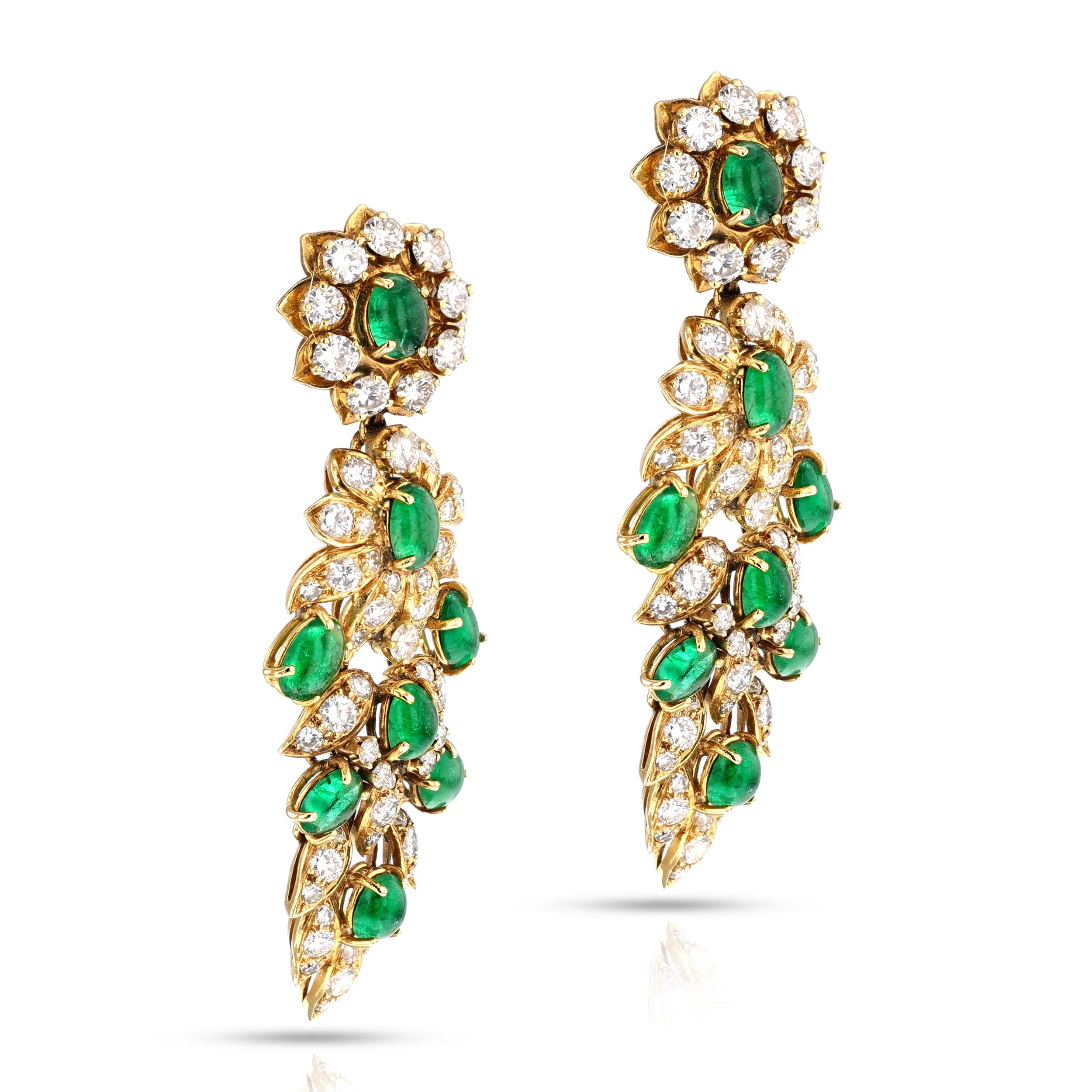 This is a beautiful and chic pair of dangle emerald and diamond earrings by Vourakis. This elegant and meticulously crafted pair of earrings is set with sixteen genuine and natural emeralds in cabochon-cut, accented with one hundred and fourteen