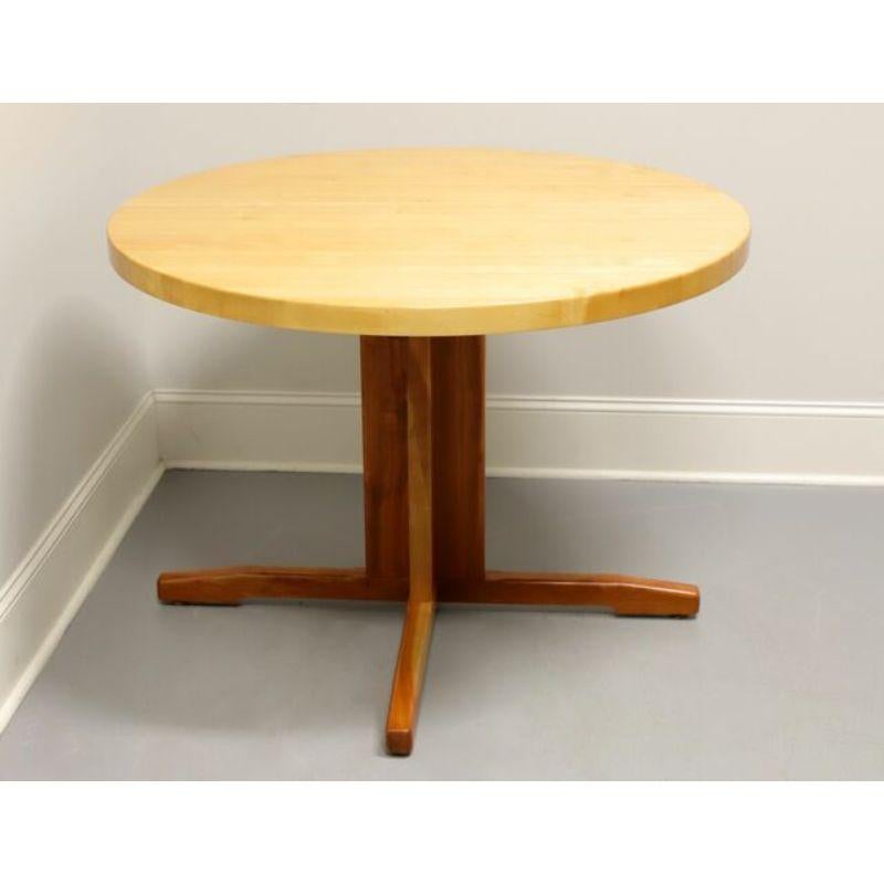 A Farmhouse style 42 inch round dining table by W.A. Mitchell of Temple, Maine, USA. Ash wood butcher block top and cherry wood 