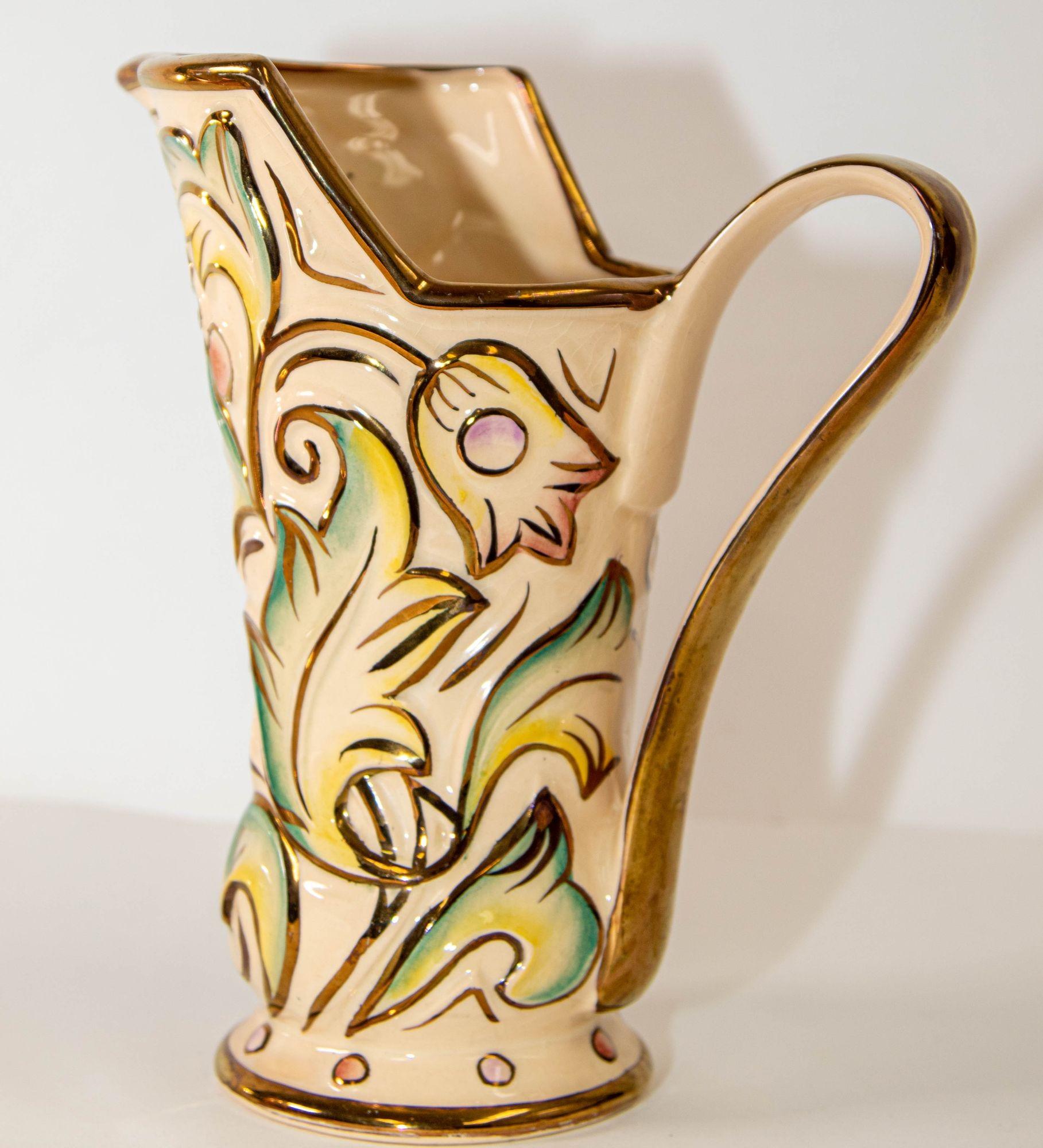 Vintage Wade Made In England Ceramic Gothic Pattern Glazed Vase in Pastel Colors with Gold Rim.
Beautiful Wade Hand Painted Pottery Gothic water jug, handled vase with an elegantly curved body.
The molded design features the 