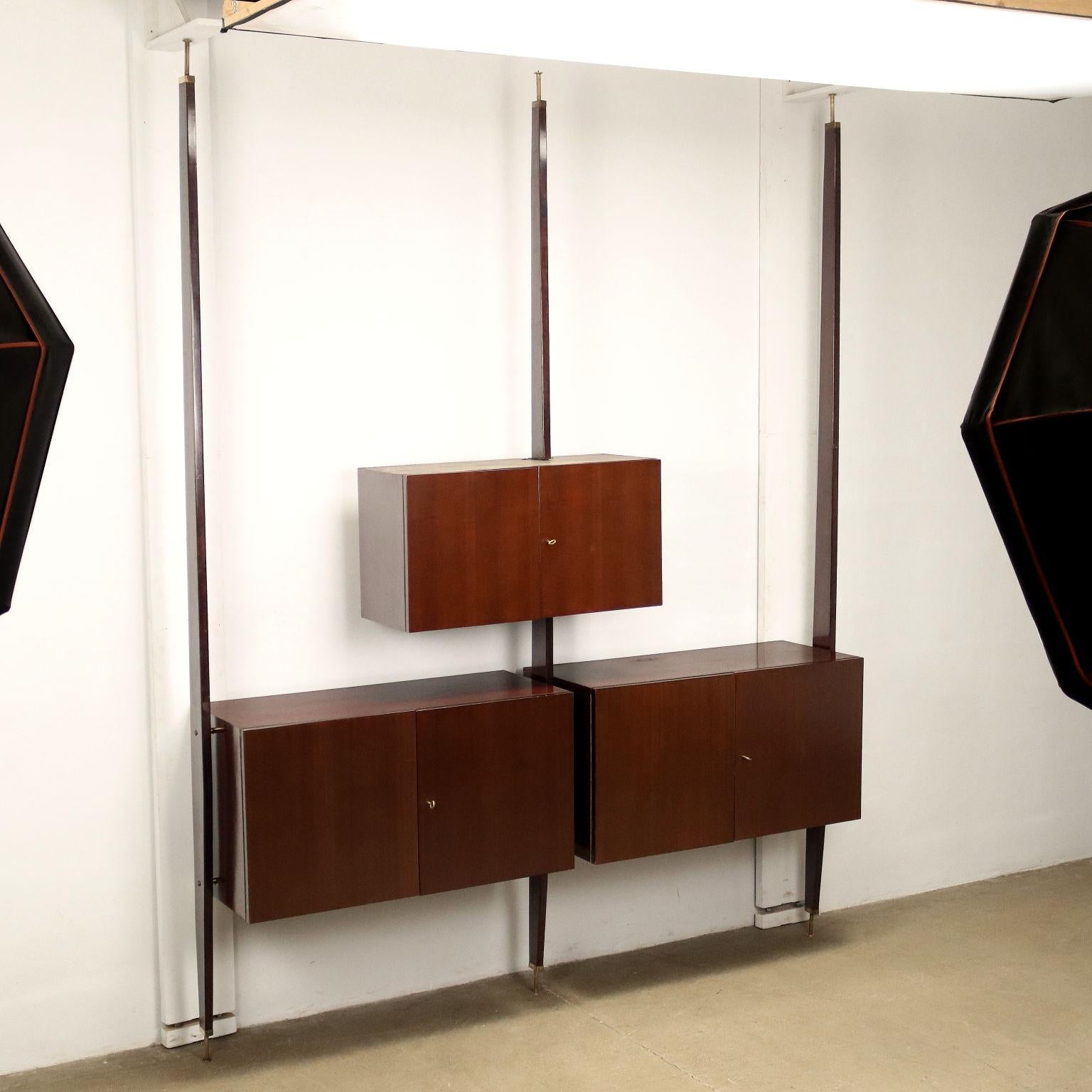 Wall unit with hinged doors in ebony-stained beech veneer.