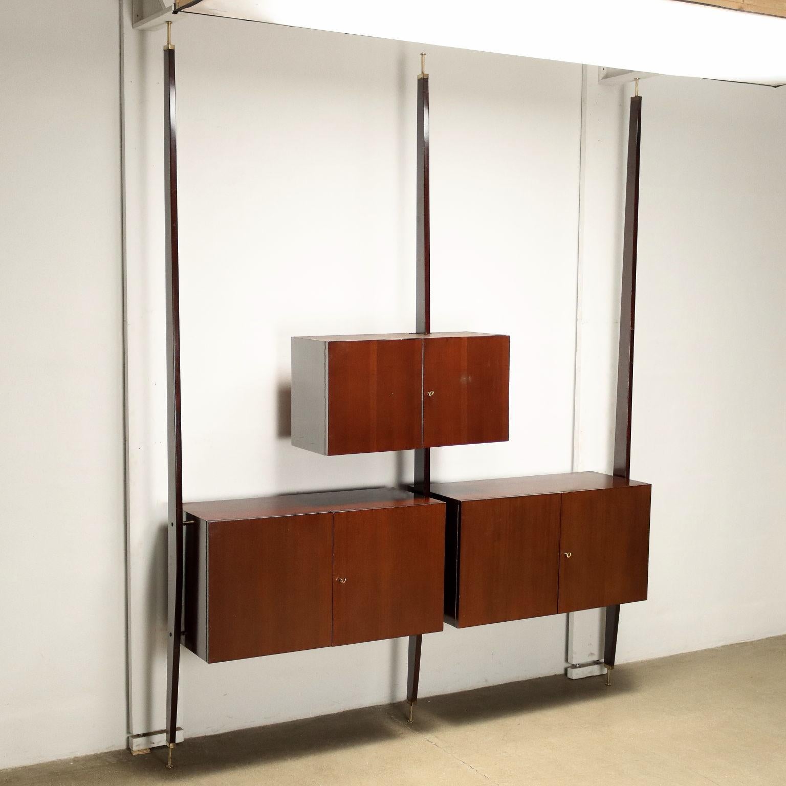 Wall unit with hinged doors in ebony-stained beech veneer.