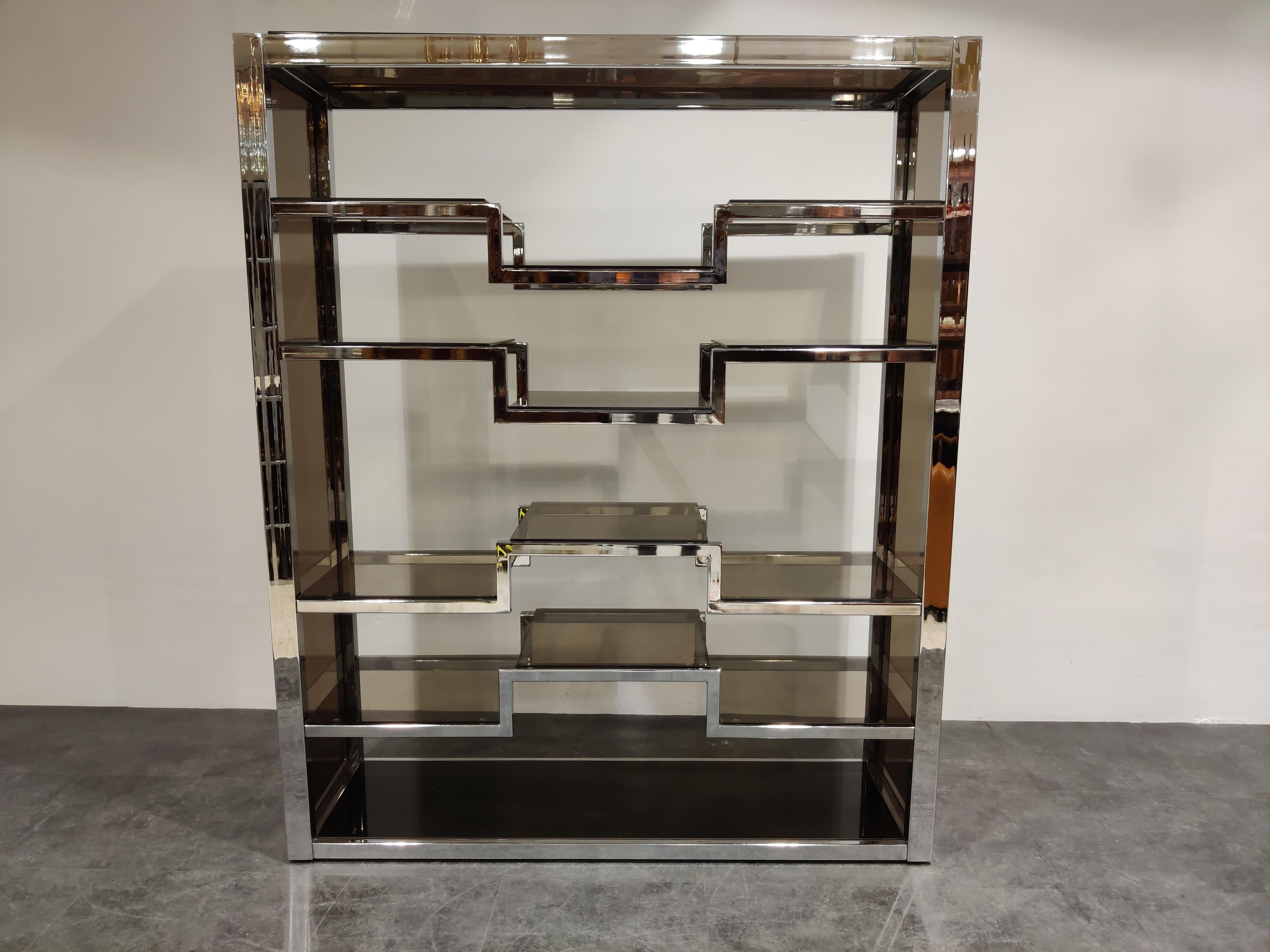 Hollywood regency wall unit or room divider with smoked glass in the style or Romeo Rega or Willy Rizzo

Bought in the 1970s from Roche Bobois

Good condition.

Glass side panels

Beautiful piece to display collections of all
