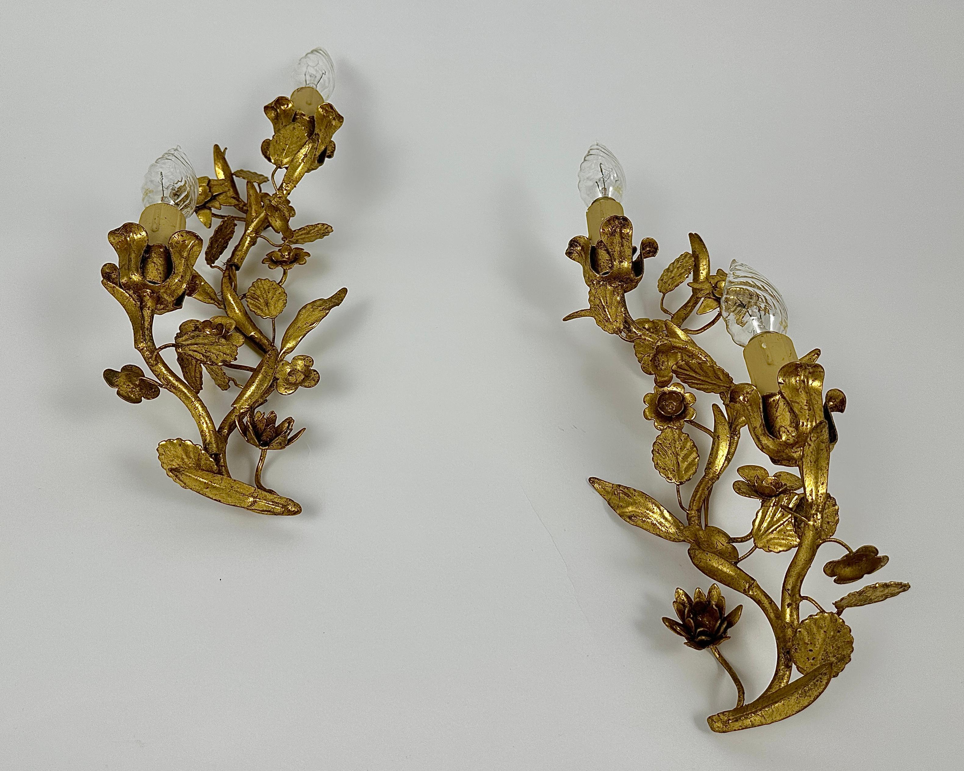 Beautiful Florentine Sconces from the 1960s with two light fixture on each.

Manufactured in Italy.

Refined sconces in flattering flowers and leaf design, it graces the wall in beautiful nature decoration. 

The lampshades are made in the form of