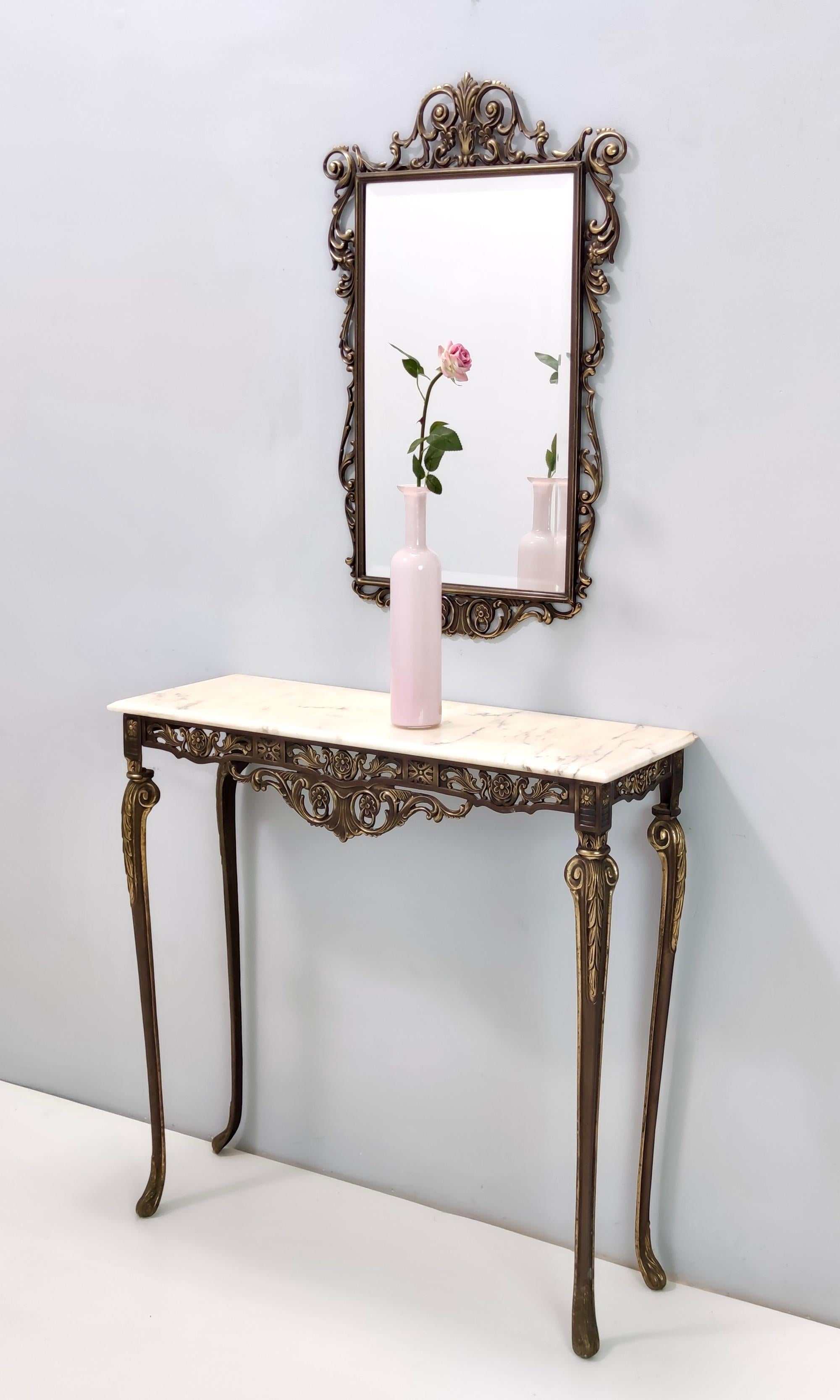 Made in Italy, 1960s.
The console table features a Portuguese pink marble top and both the mirror and the console have a cast brass frame.
They might show slight traces of use since they are vintage, but they can be considered as in excellent