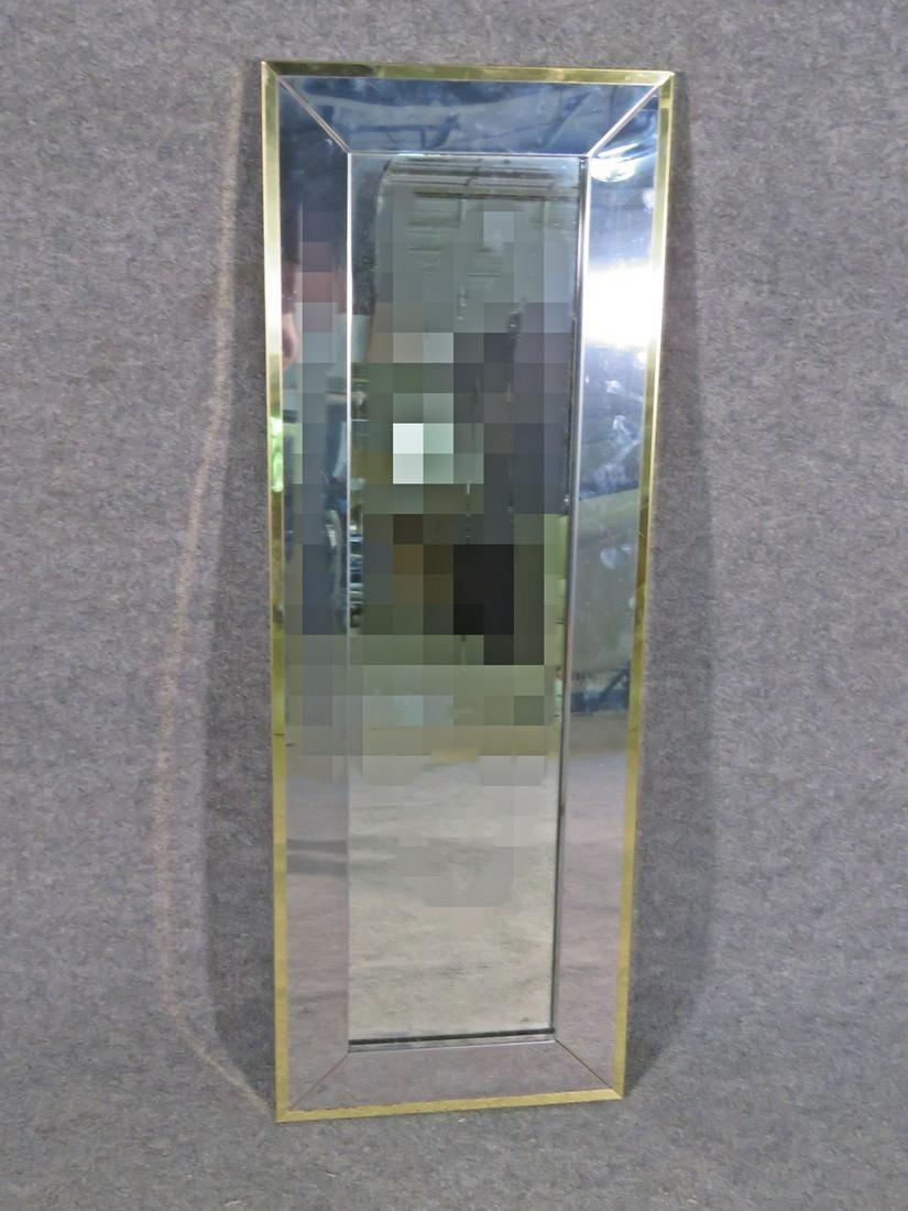 With contrasting shades of metal and an elegant design, this wall mirror in the style of Paul Evans is both subtle and eye-catching. Please confirm item location with seller (NY/NJ).