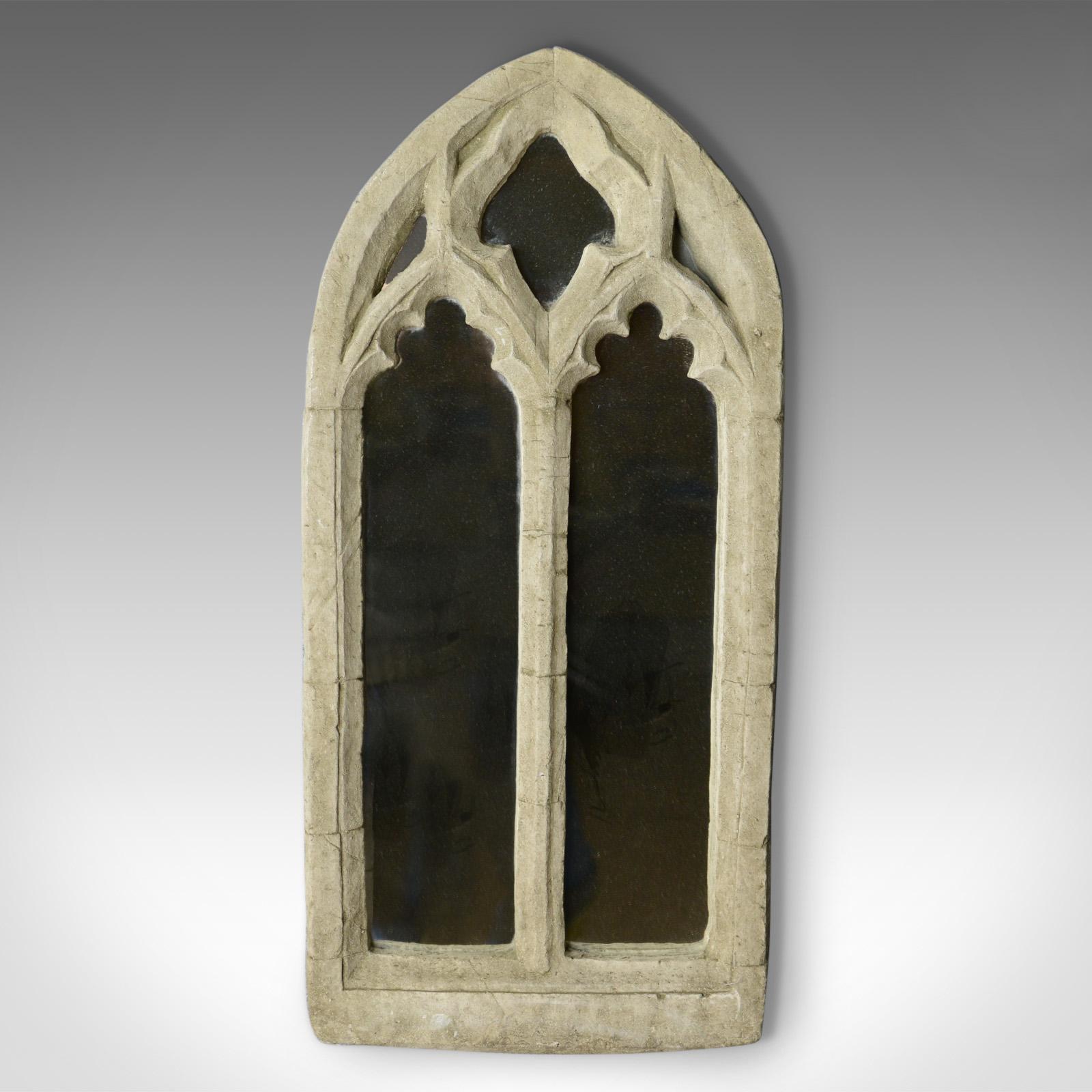 This is a vintage wall mirror, a Pugin-esque, Gothic Revival composite stone frame with ecclesiastical overtones dating to the mid 20th century.

Heavy composite stone frame
Quality mirror plate
Of quality composite stone 
Five apertures with