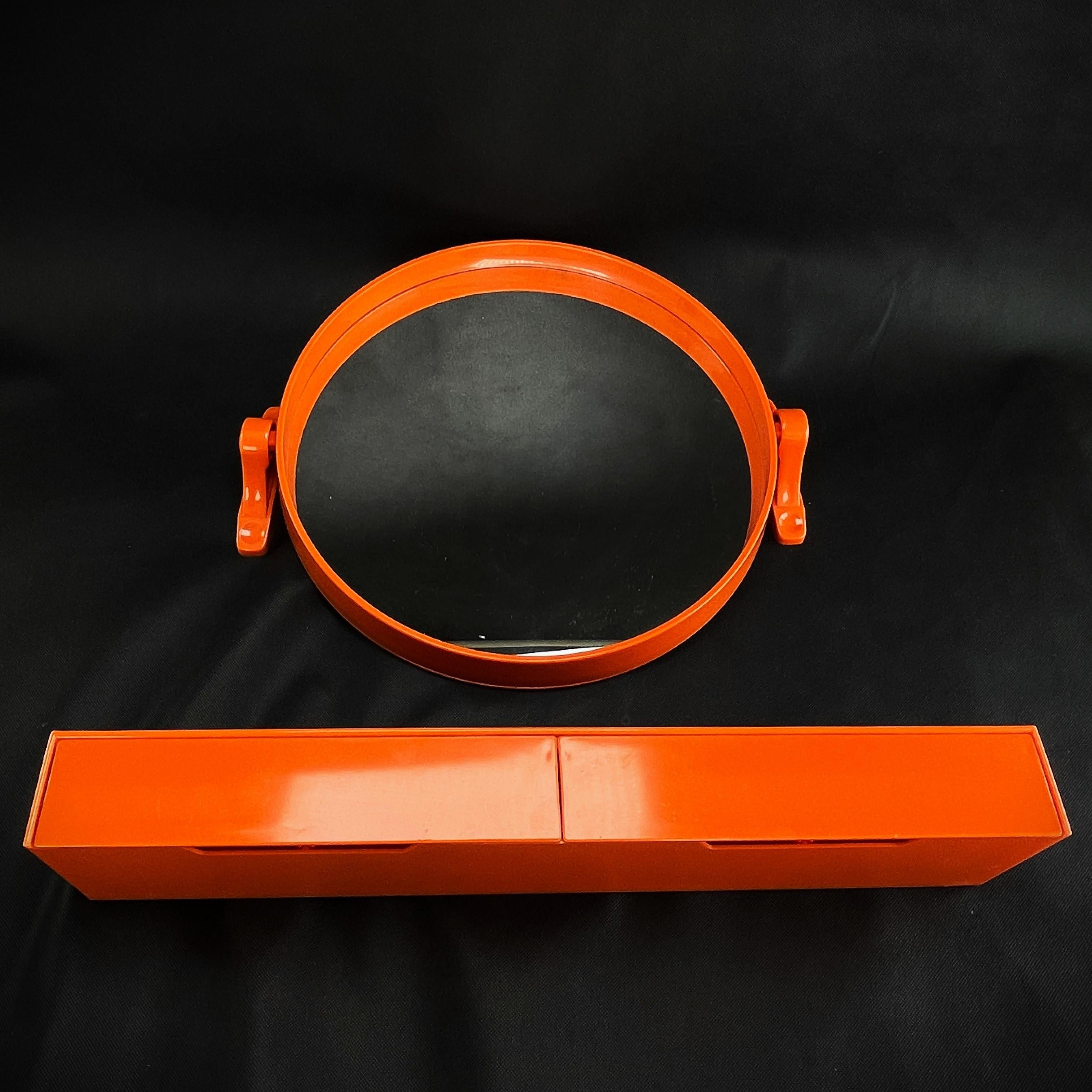 Orange Wall mirror with storage board - 1970s

The designer of this extraordinary object managed to combine functionality, design, style and aesthetics. Even today, this mirror is an absolute eye-catcher.
The midcentury mirror is a stunning wall