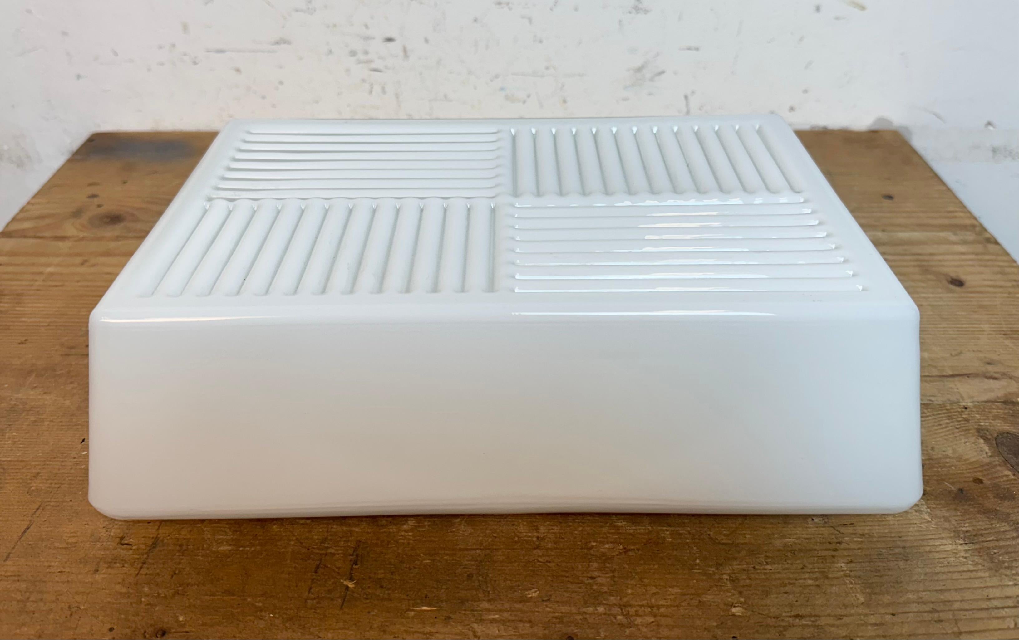 Vintage Industrial rectangle wall or ceiling lamp made in former Czechoslovakia during the 1970s. Was used in factory offices and corridors. It features a metal back and an embossed milk glass cover. The socket requires standard E 27/ E26 light