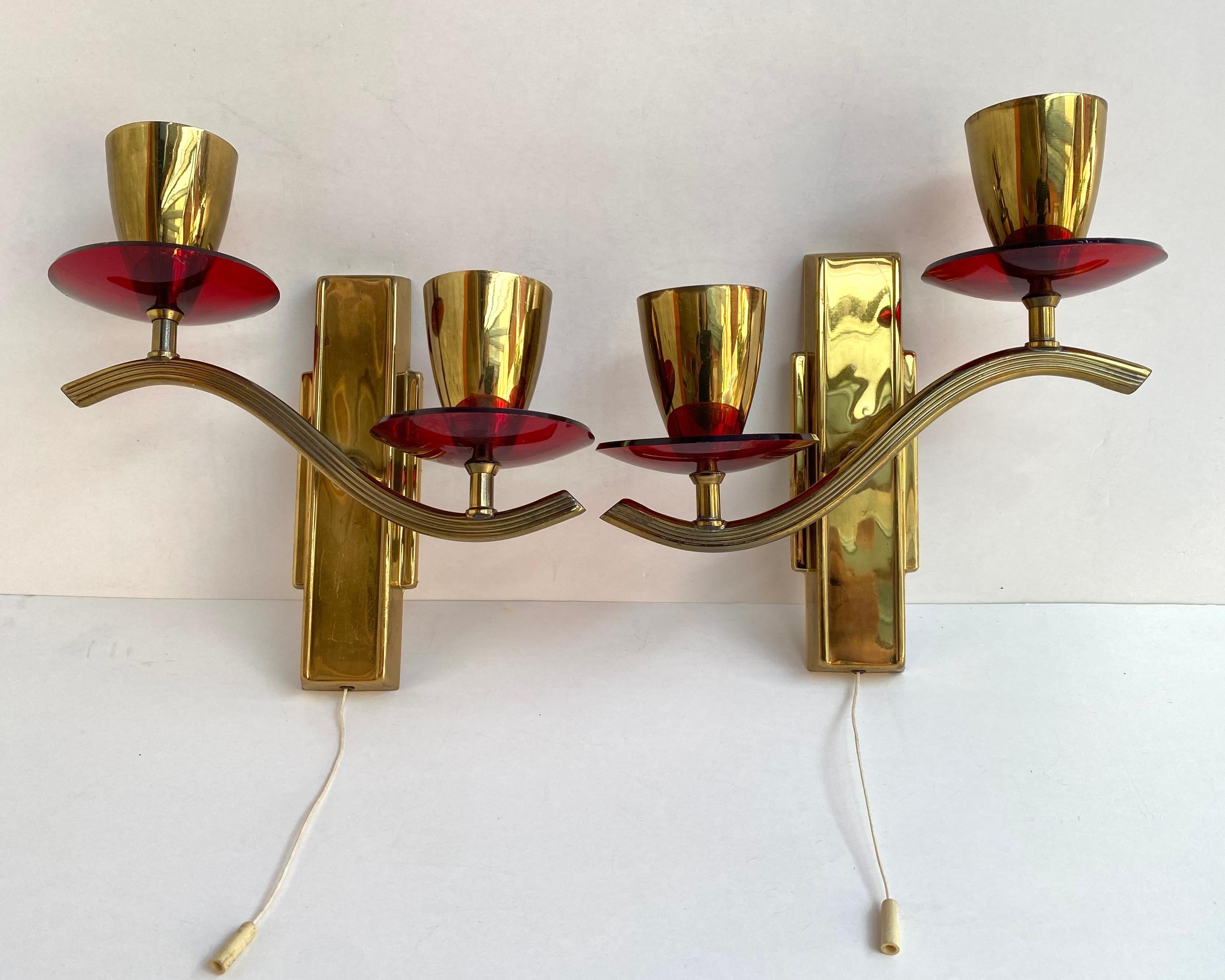 Stylish Paired wall sconces in beautiful gilt brass and ruby plexiglass decorative elements from the German manufacturer. 1970s.

Vintage Set of Wall Lighting lamps with 2 horns on each.

Very noble and sensual! Such wall lamps will effectively