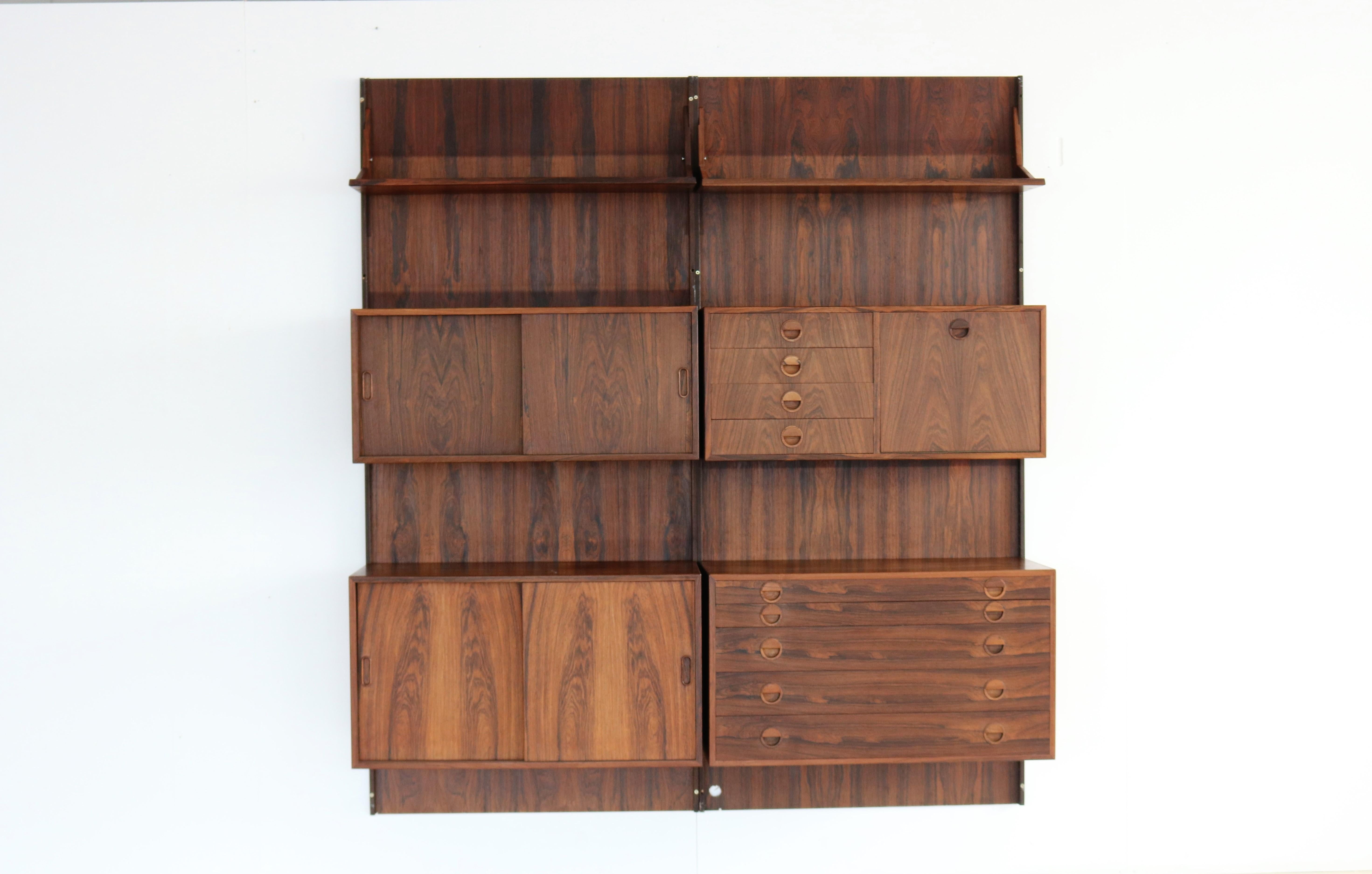 Vintage wall system rosewood HG Furniture Danish.

Rosewood wall system designed by Rud Thygesen & Johnny Sorensen for HG Furniture. The system is of high quality and can be arranged according to your own wishes.

Period 1960s.
Designs Rud