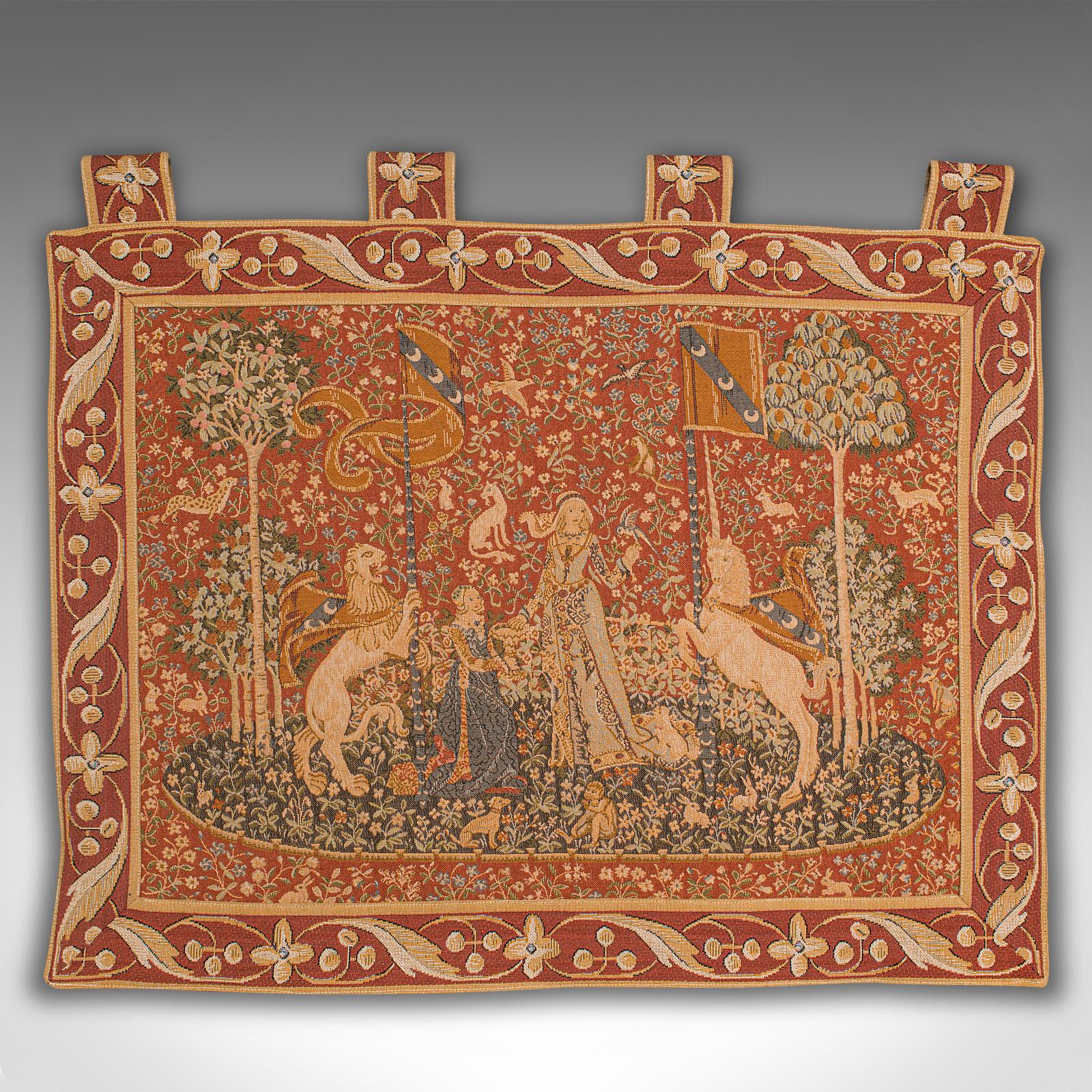 This is a vintage wall tapestry. An English, needlepoint scene depicting The Lady and the Unicorn, dating to the late 20th century, circa 1980.

This striking tapestry is a quality recreation of the 15th century renaissance series of tapestries