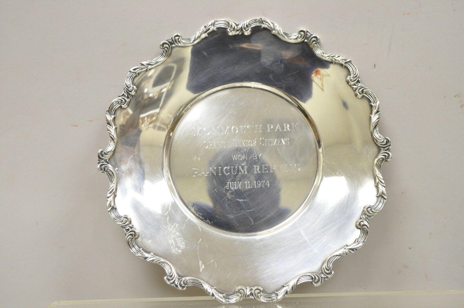Vintage Wallace 1125 Silver Plated Monmouth Park Award Plates. Item features scalloped Edges, original hallmark.
Plate 1 reads: “MONMOUTH PARK ORANGE SENIOR CITIZENS WON BY PANICUM REPENS JULY 11, 1974”
Plate 2 reads: “MONMOUTH PARK J.J. COMPOSITE