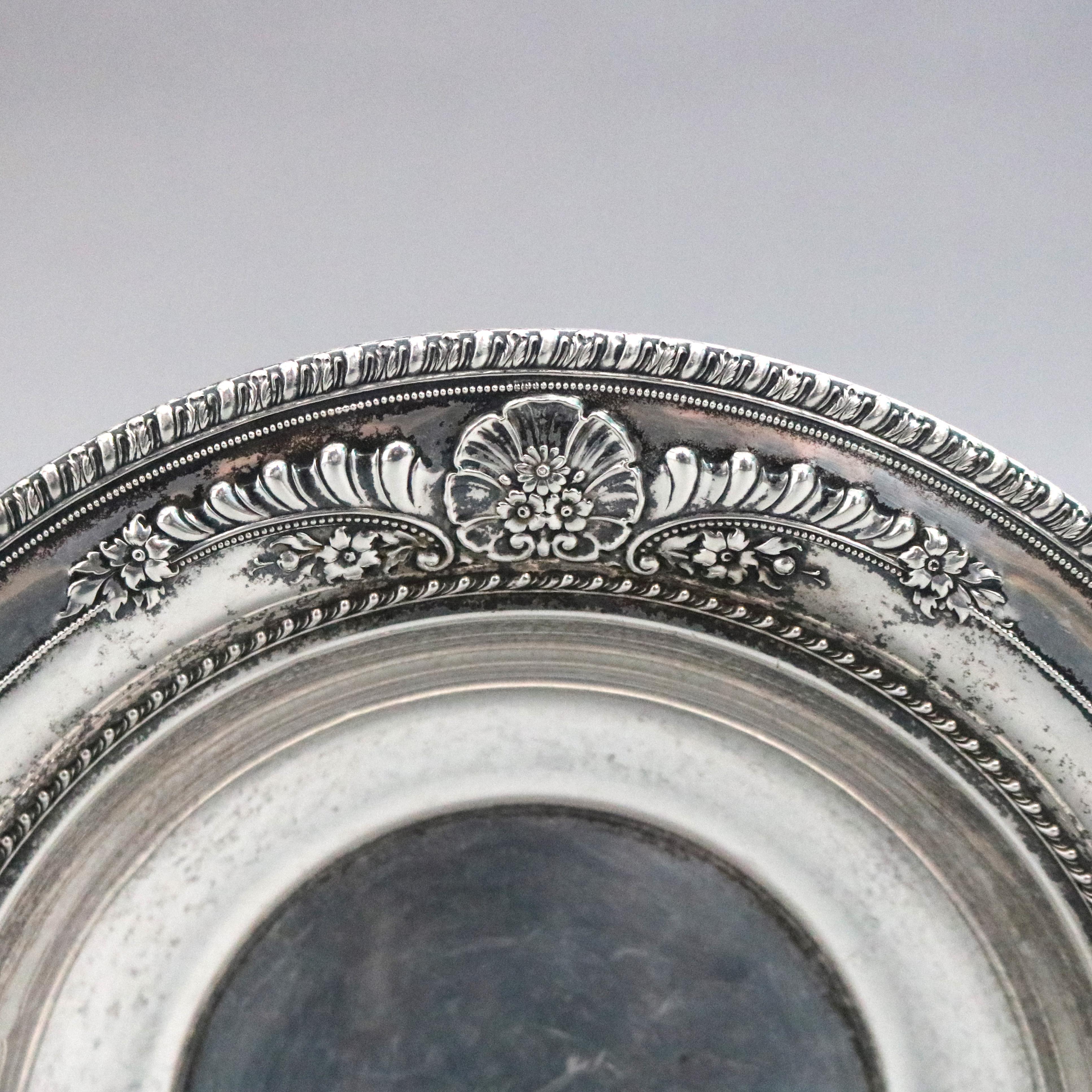 A vintage serving bowl by Wallace offers sterling silver construction with Repousse floral elements marked on base as photographed, circa 1930

Measures: 2